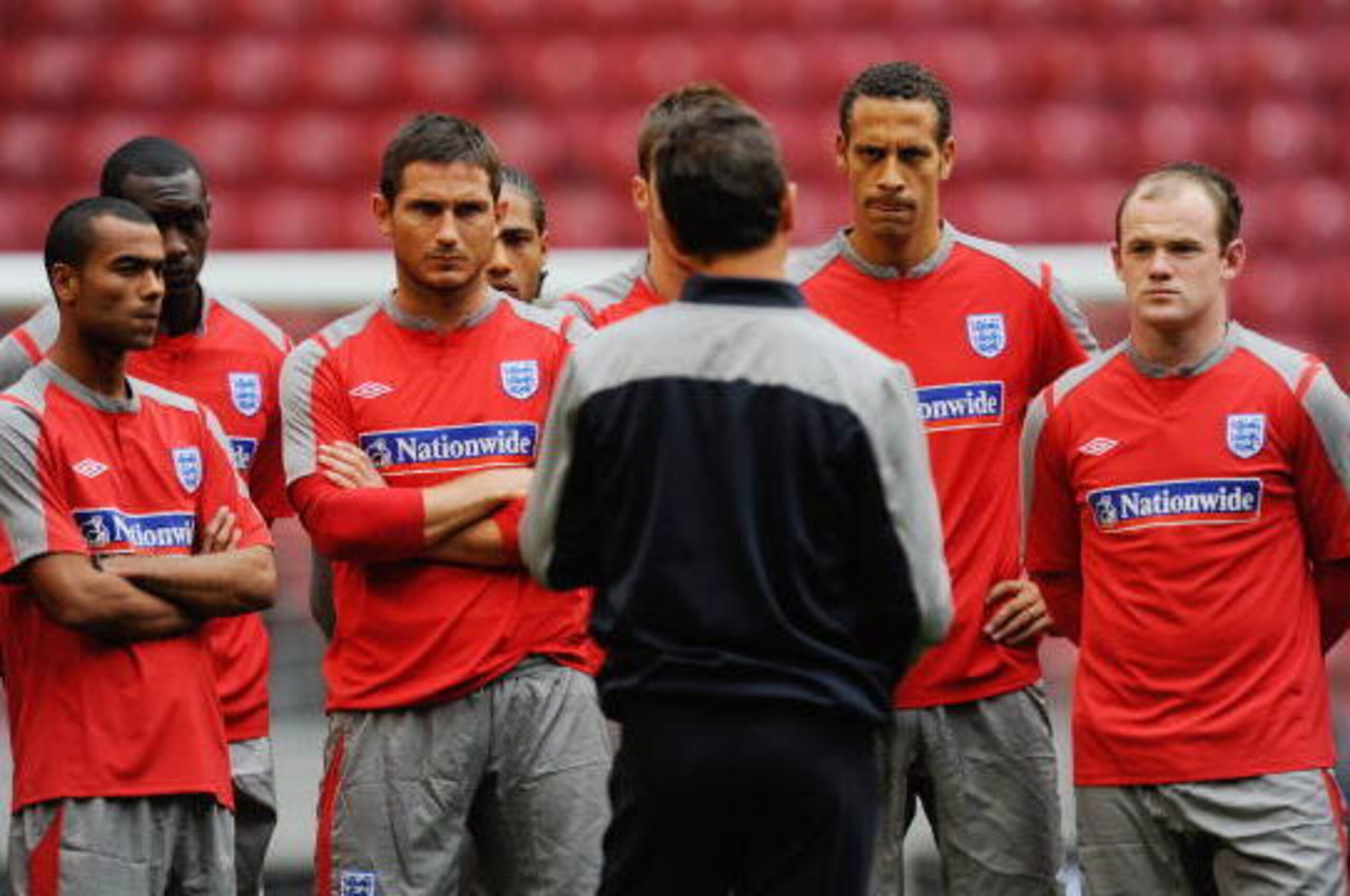AMSTERDAM, NETHERLANDS - AUGUST 11: Ashley Cole, Frank Lampard, Rio Ferdinand and Wayne Rooney listen to England manager Fabio Capello  during the England Training Session at the Amsterdam Arena on August 11, 2009 in Amsterdam, Netherlands.  (Photo by Mic