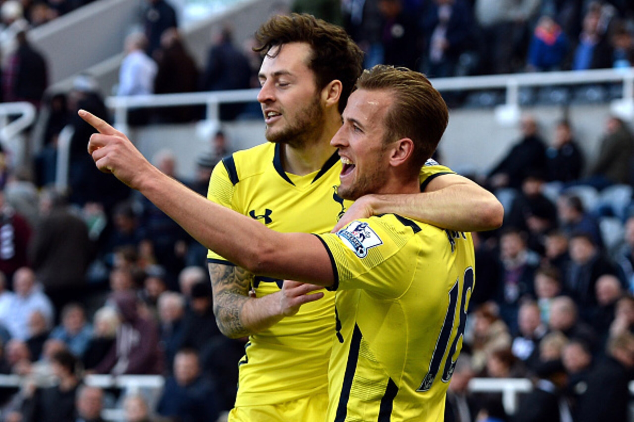 NEWCASTLE UPON TYNE, ENGLAND - APRIL 19:  Harry Kane of Spurs celebrates scoring their third goal with Ryan Mason of Spurs (L) during the Barclays Premier League match between Newcastle United and Tottenham Hotspur at St James' Park on April 19, 2015 in N