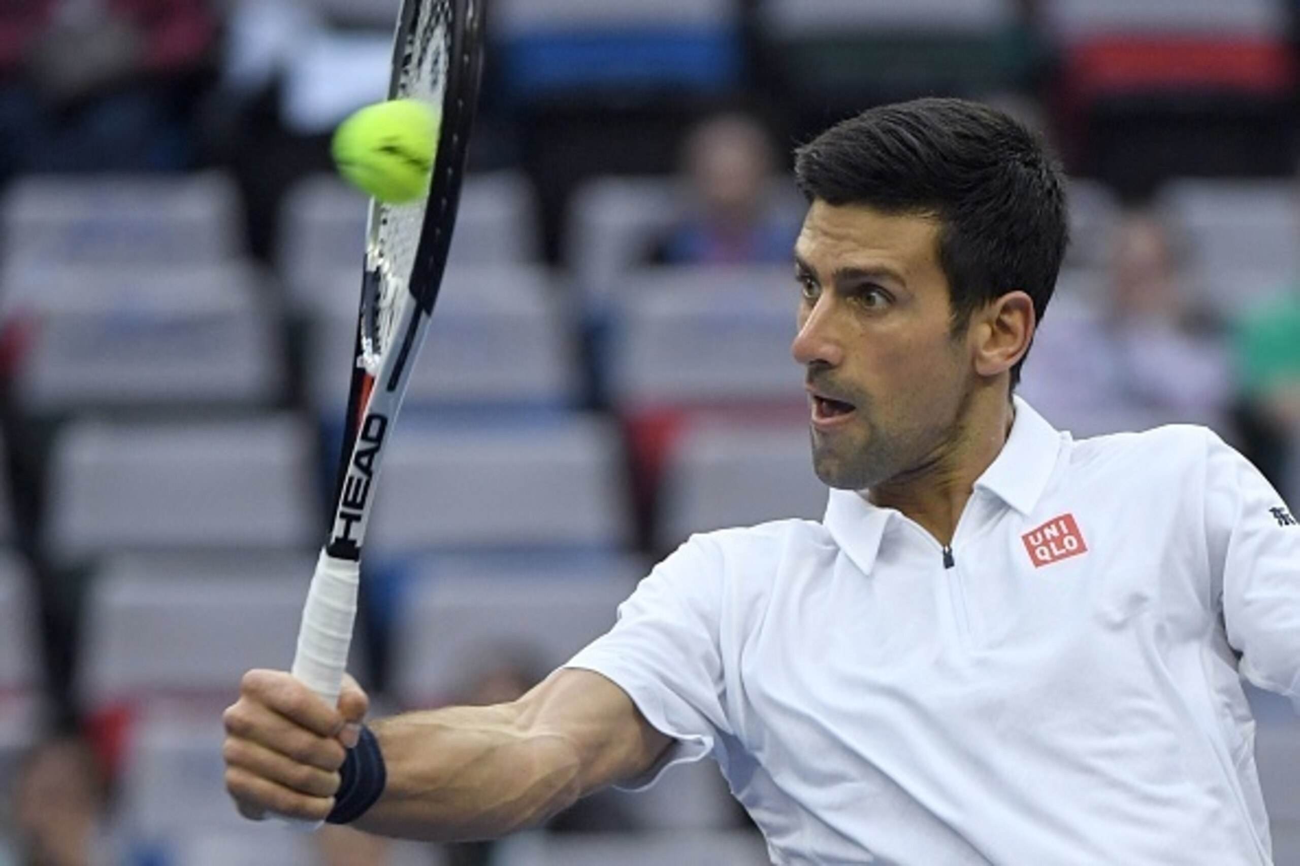 Novak Djokovic of Serbia hits a return against Vasek Pospisil of Canada during the men's singles match at the Shanghai Masters tennis tournament in Shanghai on October 13, 2016. / AFP / WANG ZHAO        (Photo credit should read WANG ZHAO/AFP/Getty Images