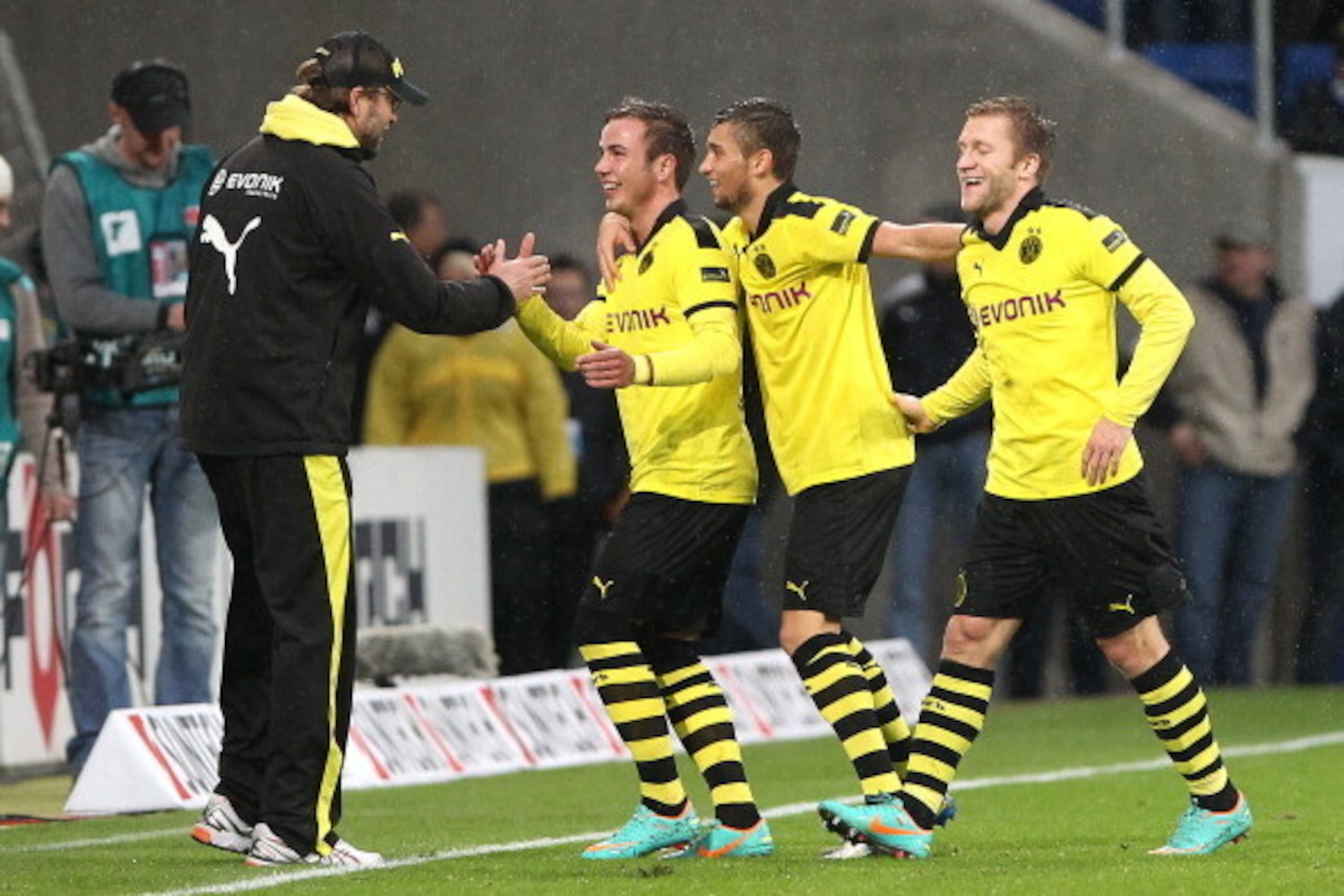 Dortmund's Mario Goetze celebrates scoring the 1-0 with Dortmund's head coach Juergen Klopp (L), Dortmund's midfielder Moritz Leitner (2nd R) and Dortmund's Polish midfielder Jakub Blaszczykowski (R) during the German first division Bundesliga football ma