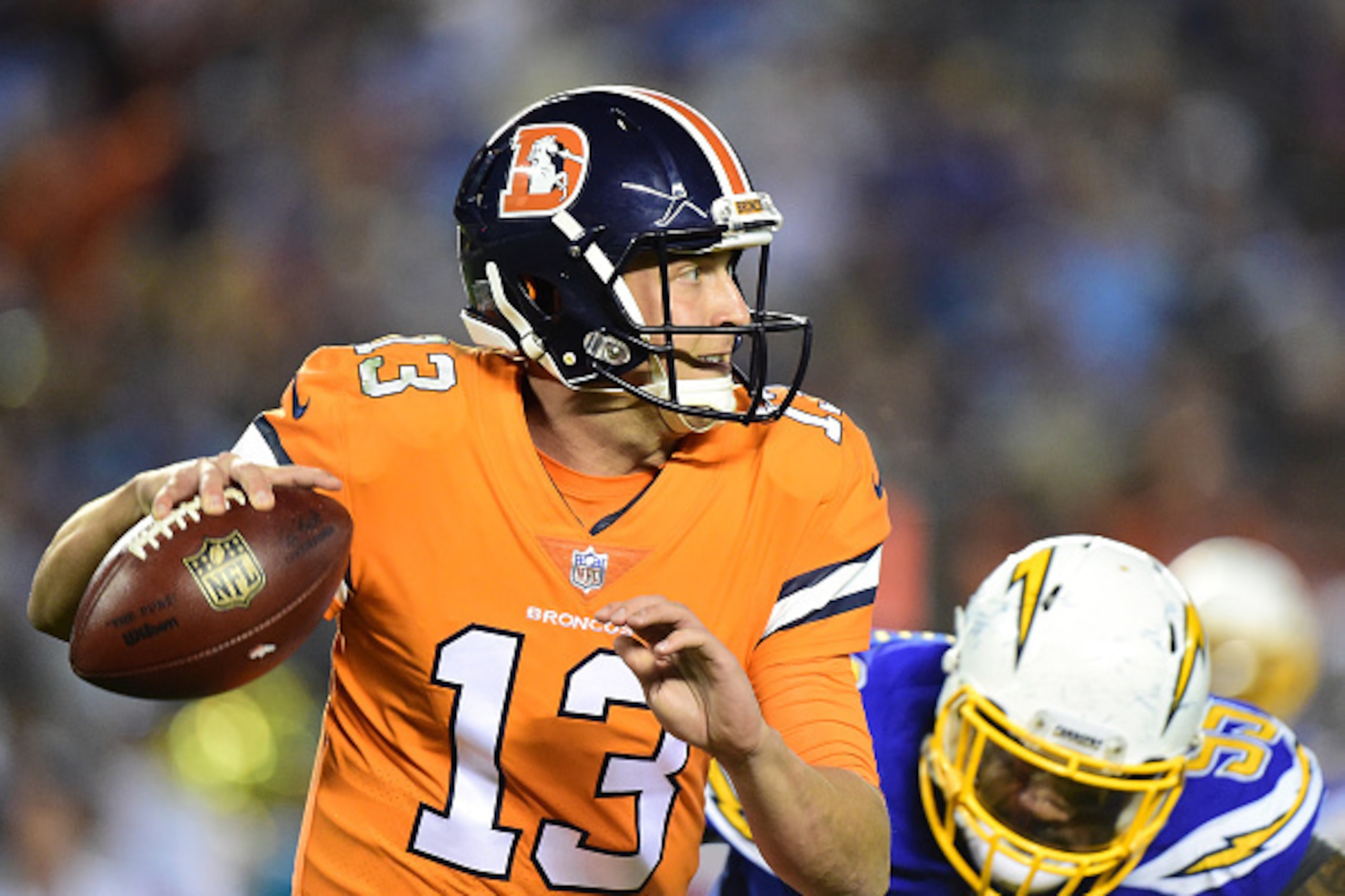 SAN DIEGO, CA - OCTOBER 13:  Trevor Siemian #13 of the Denver Broncos scrambles from Tenny Palepoi #95 of the San Diego Chargers during the third quarter of a 21-13 Charger win at Qualcomm Stadium on October 13, 2016 in San Diego, California.  (Photo by H