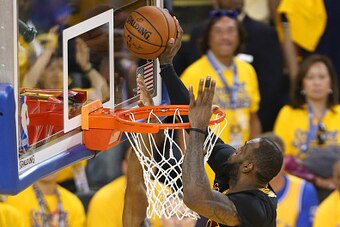 OAKLAND, CA - JUNE 19:  LeBron James #23 of the Cleveland Cavaliers blocks a shot against Andre Iguodala #9 of the Golden State Warriors during Game Seven of the 2016 NBA Finals on June 19, 2016 at ORALCE Arena in Oakland, California. NOTE TO USER: User e