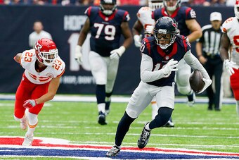 HOUSTON, TX - SEPTEMBER 18: DeAndre Hopkins #10 of the Houston Texans breaks the tackle attempt of Phillip Gaines #23 of the Kansas City Chiefs at NRG Stadium on September 18, 2016 in Houston, Texas.  (Photo by Bob Levey/Getty Images)