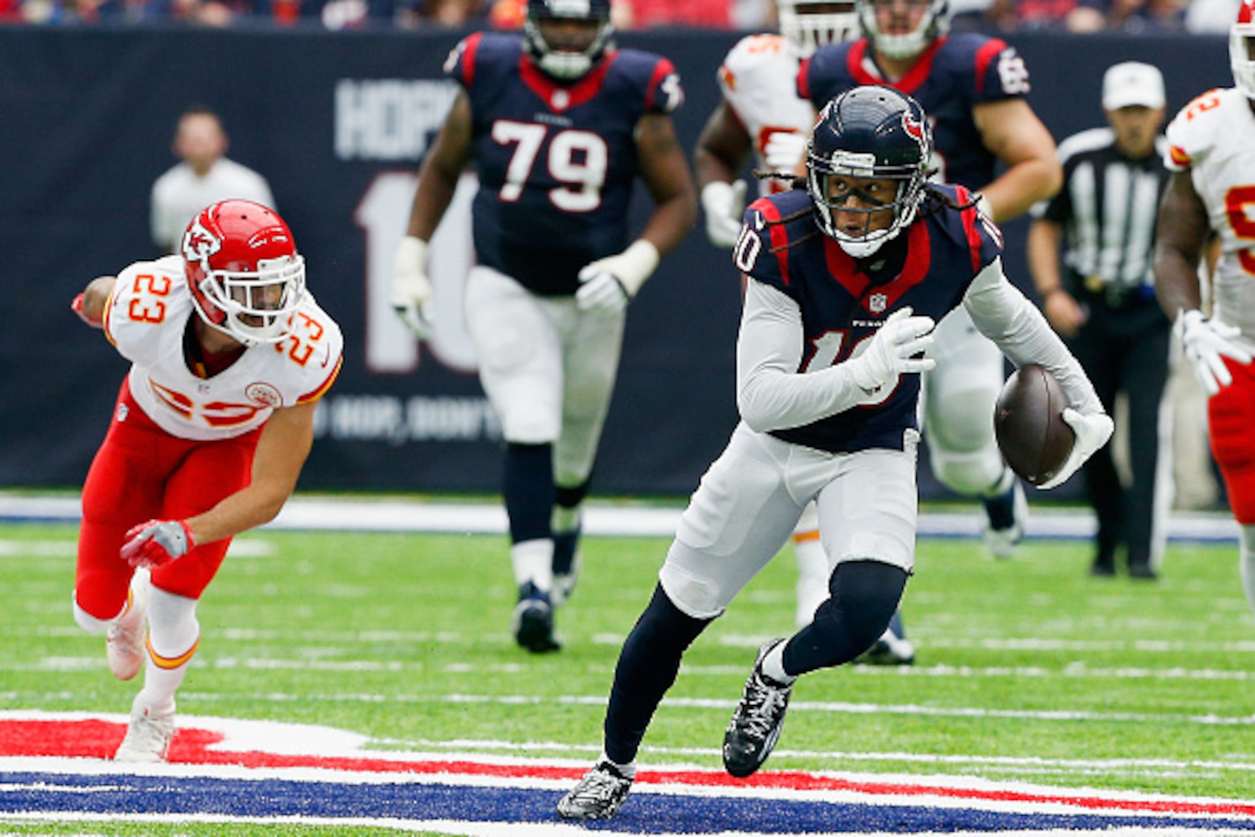 HOUSTON, TX - SEPTEMBER 18: DeAndre Hopkins #10 of the Houston Texans breaks the tackle attempt of Phillip Gaines #23 of the Kansas City Chiefs at NRG Stadium on September 18, 2016 in Houston, Texas.  (Photo by Bob Levey/Getty Images)
