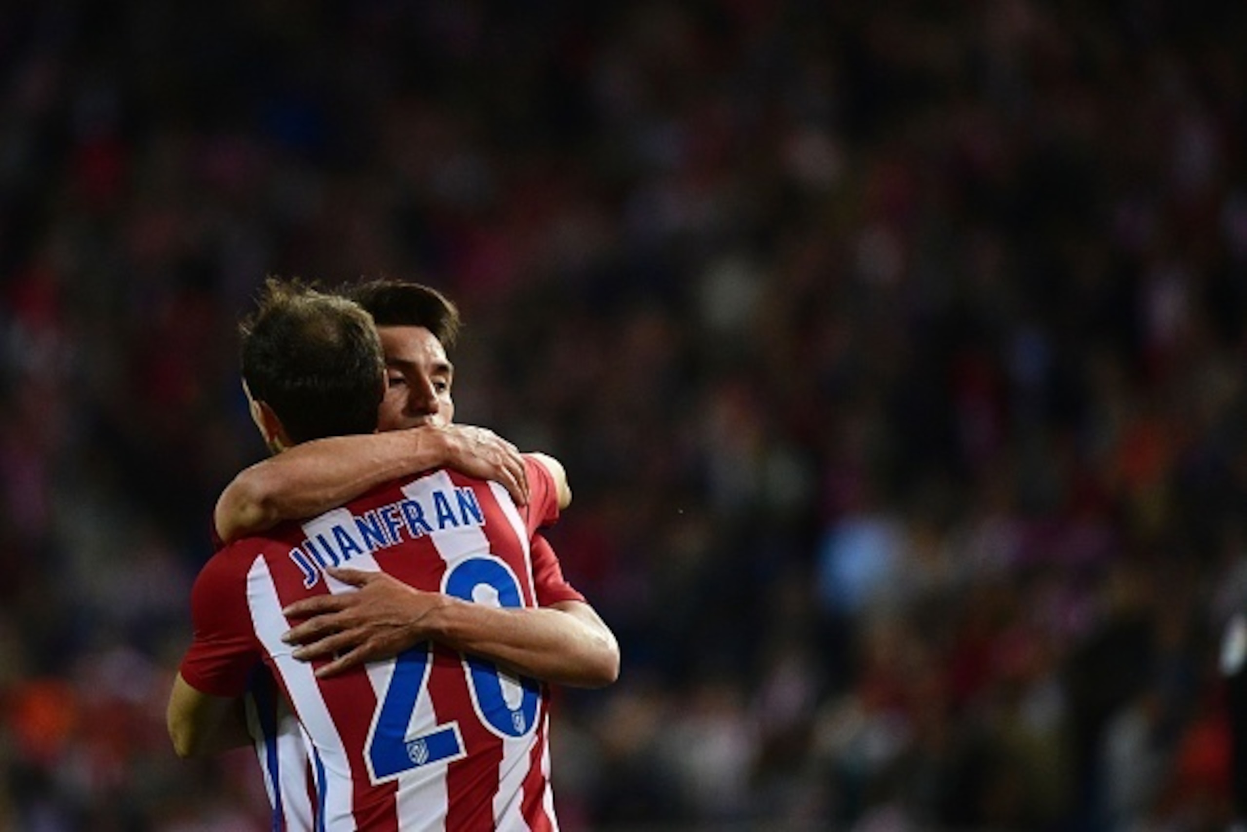 Atletico Madrid's Argentinian midfielder Nicolas Gaitan (R) celebrates his second goal with Atletico Madrid's defender Juanfran during the Spanish league football match Club Atletico de Madrid vs Granada FC at the Vicente Calderon stadium in Madrid on Oct