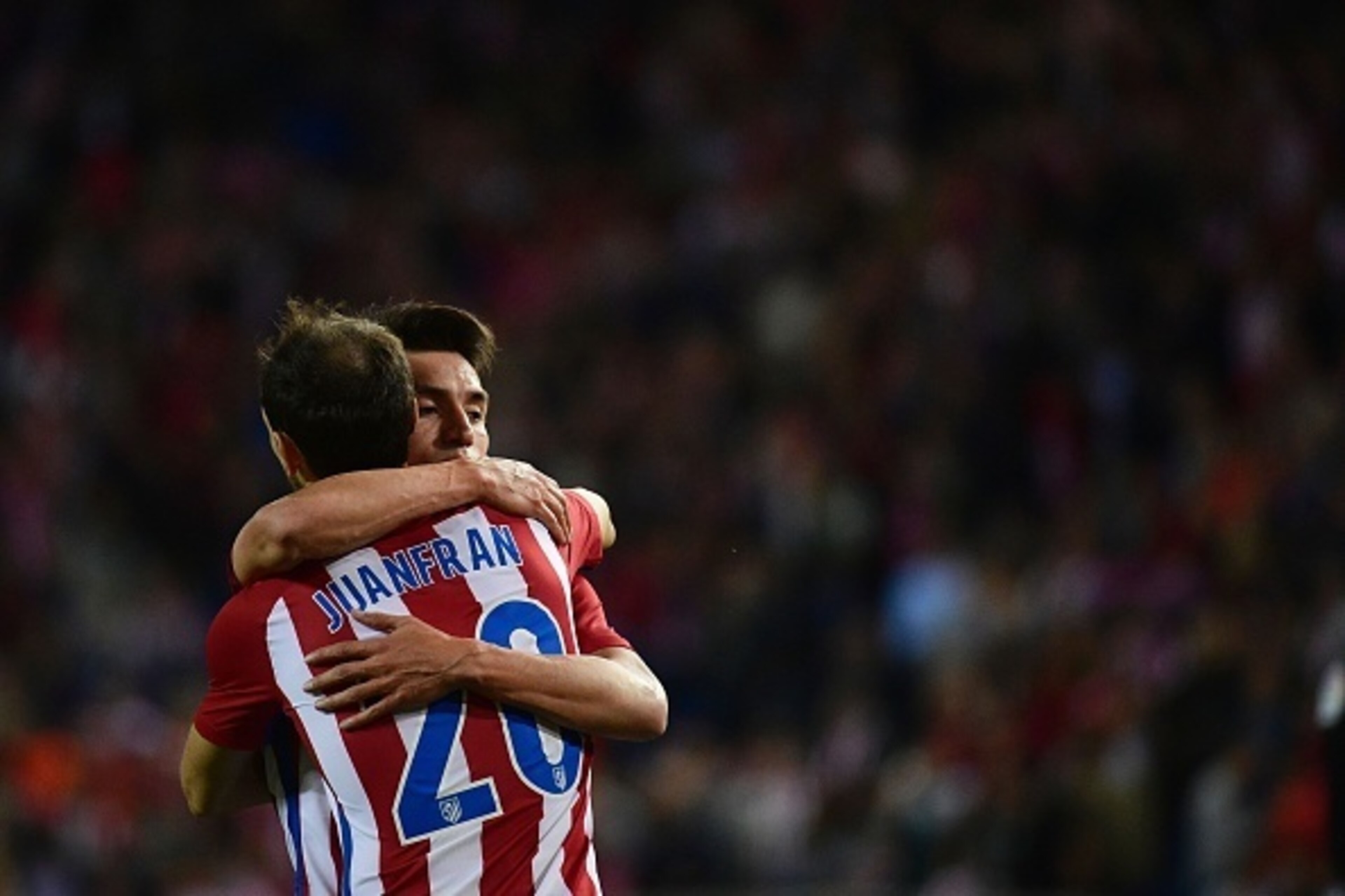 Atletico Madrid's Argentinian midfielder Nicolas Gaitan (R) celebrates his second goal with Atletico Madrid's defender Juanfran during the Spanish league football match Club Atletico de Madrid vs Granada FC at the Vicente Calderon stadium in Madrid on Oct