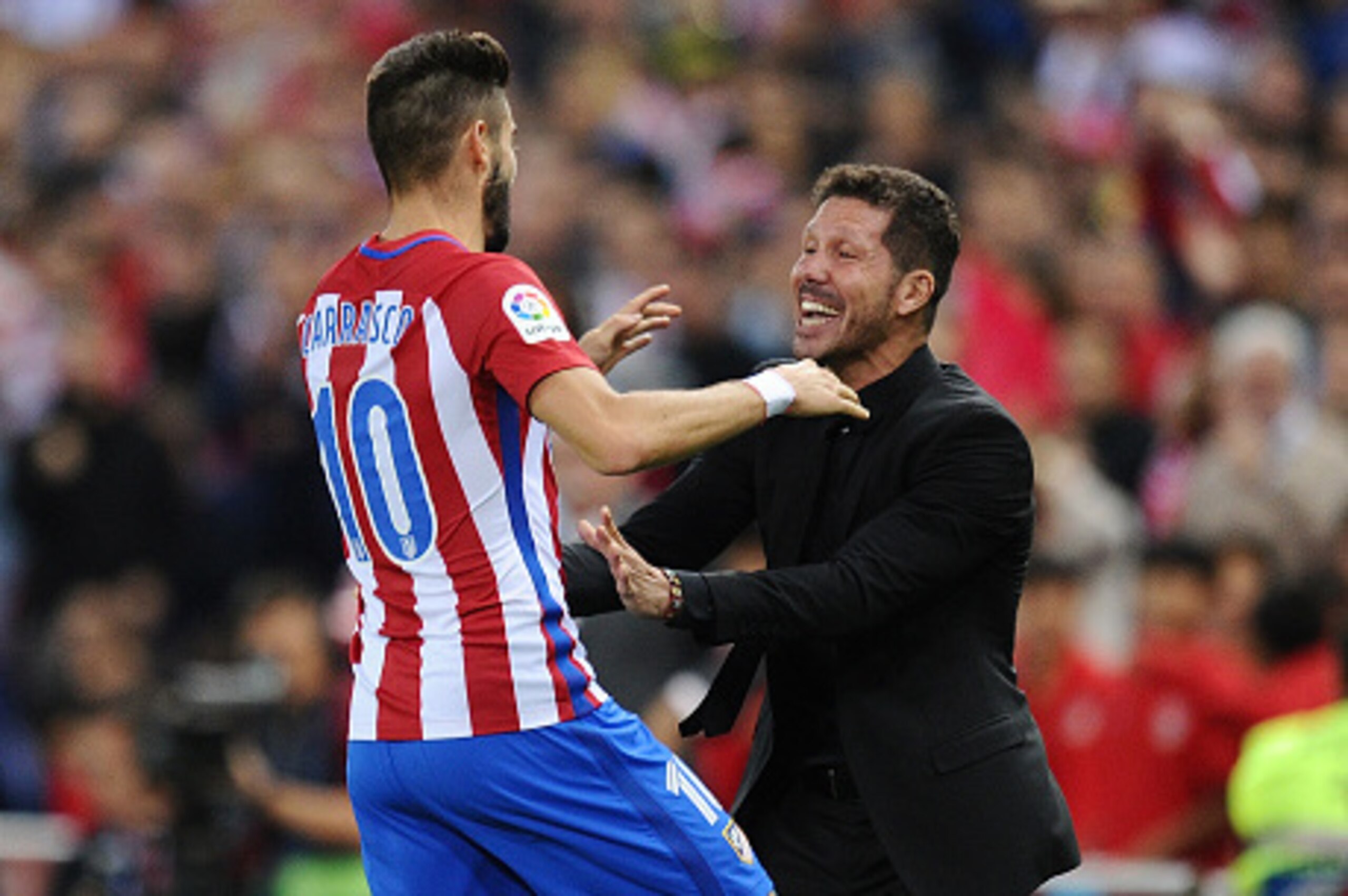 MADRID, SPAIN - OCTOBER 15:  Yannick Carrasco of Club Atletico de Madrid celebrates with his Manager Diego Simeone after scoring his 3rd goal during the La Liga match between Club Atletico de Madrid and Granada CF at Vicente Calderon Stadium on October 15