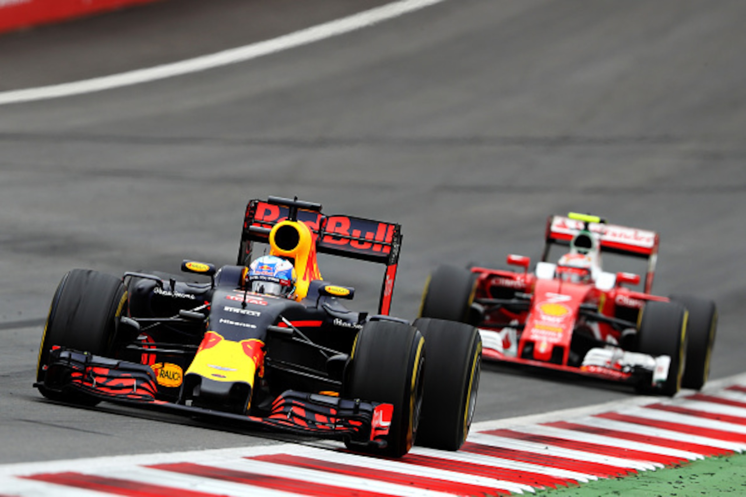 SPIELBERG, AUSTRIA - JULY 03: Daniel Ricciardo of Australia driving the (3) Red Bull Racing Red Bull-TAG Heuer RB12 TAG Heuer leads Kimi Raikkonen of Finland driving the (7) Scuderia Ferrari SF16-H Ferrari 059/5 turbo (Shell GP) on track during the Formul