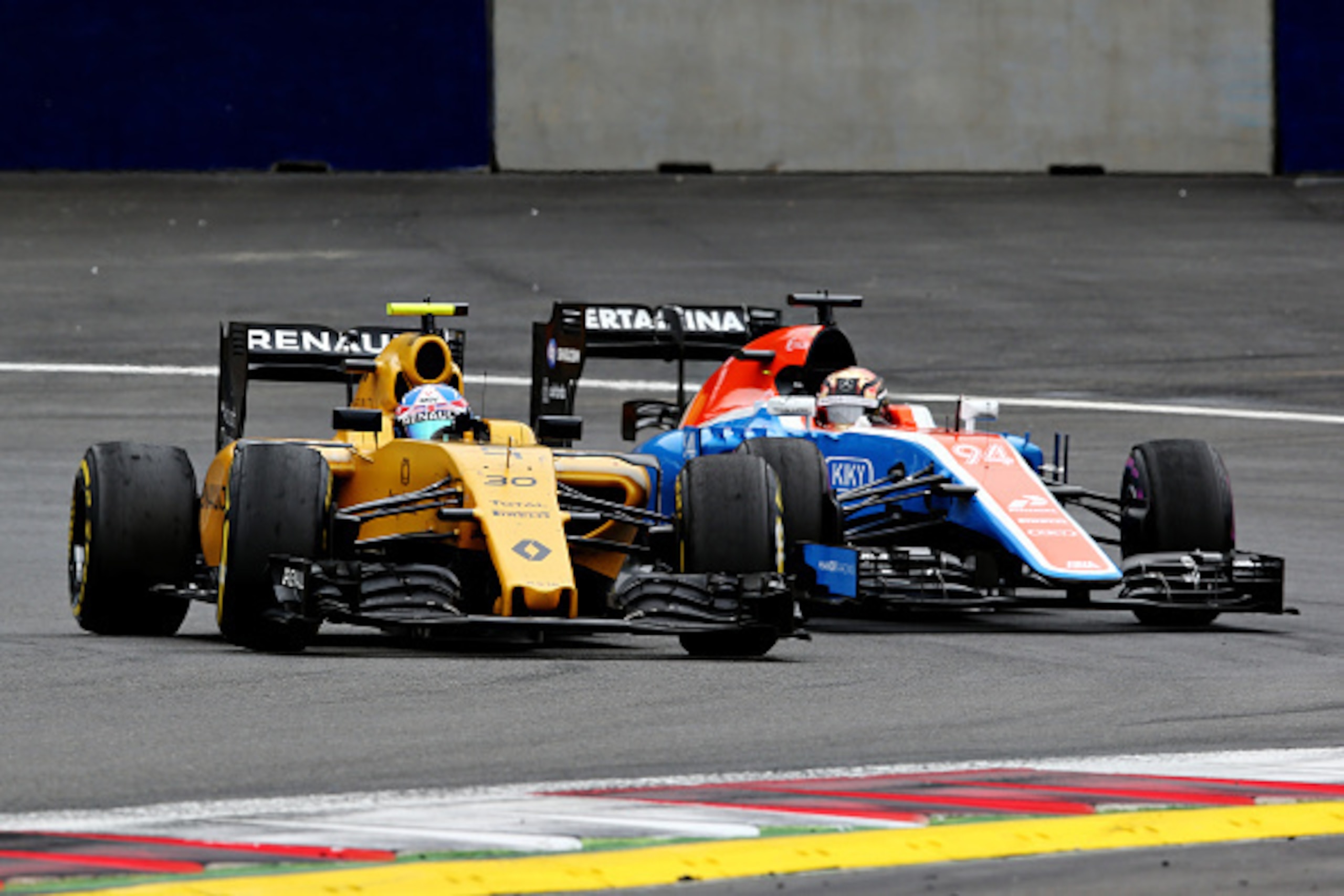 SPIELBERG, AUSTRIA - JULY 03: Jolyon Palmer of Great Britain driving the (30) Renault Sport Formula One Team Renault RS16 Renault RE16 turbo leads Pascal Wehrlein of Germany driving the (94) Manor Racing MRT-Mercedes MRT05 Mercedes PU106C Hybrid turbo on 