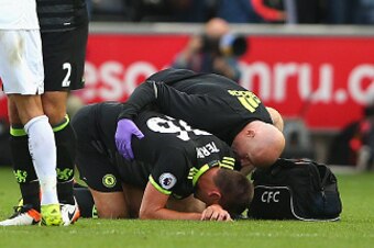 SWANSEA, WALES - SEPTEMBER 11:  Jack Cork of Swansea City and Branislav Ivanovic of Chelsea embrace as John Terry of Chelsea is given treatment after the Premier League match between Swansea City and Chelsea at Liberty Stadium on September 11, 2016 in Swa