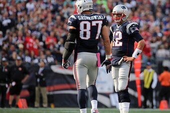 FOXBORO, MA - OCTOBER 16:   Rob Gronkowski #87 and Tom Brady #12 of the New England Patriots talk during the game against the Cincinnati Bengals at Gillette Stadium on October 16, 2016 in Foxboro, Massachusetts.  (Photo by Jim Rogash/Getty Images)