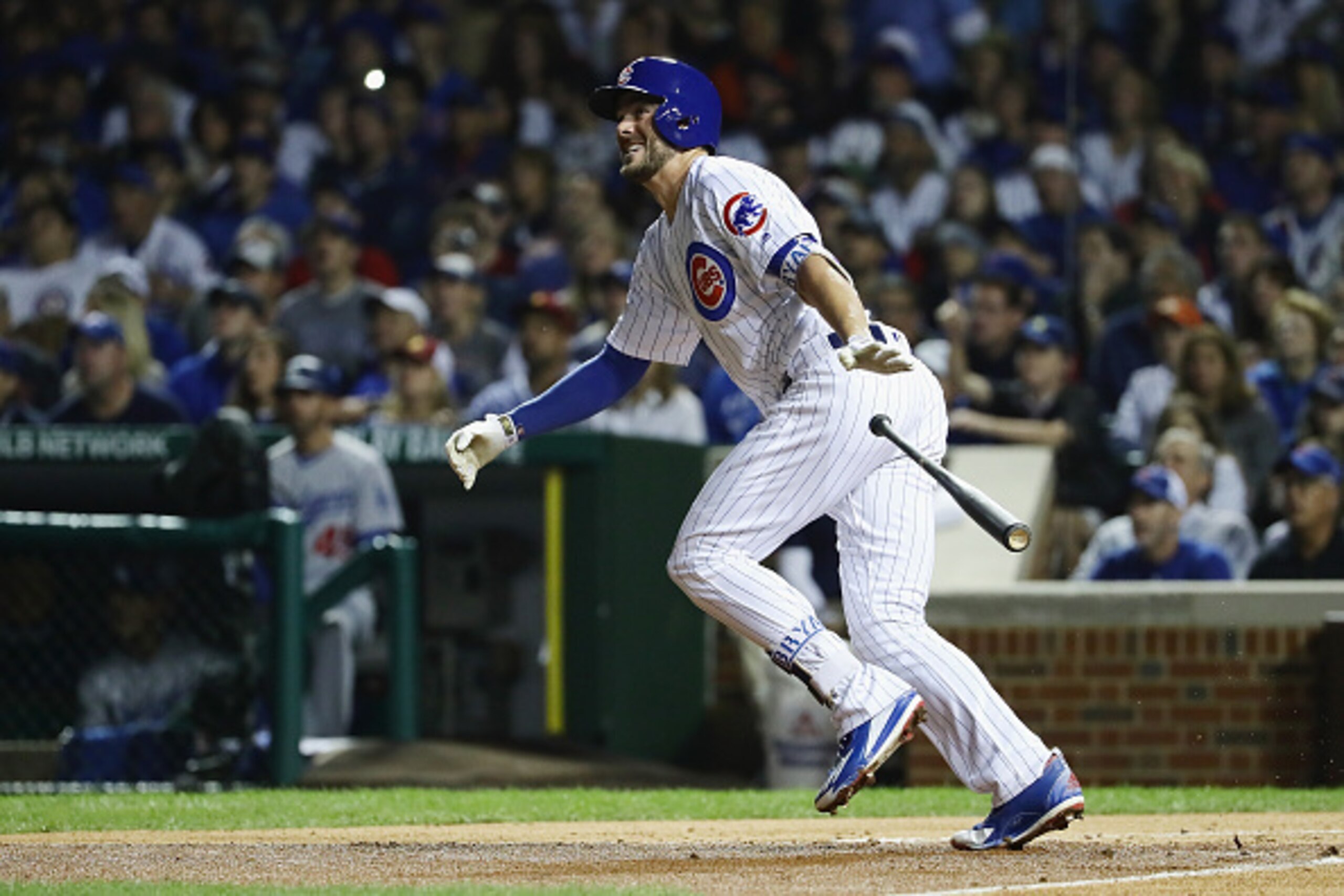 CHICAGO, IL - OCTOBER 15:  Kris Bryant #17 of the Chicago Cubs tosses his bat after hitting an RBI double to score Dexter Fowler #24 (not pictured) in the first inning against the Los Angeles Dodgers during game one of the National League Championship Ser