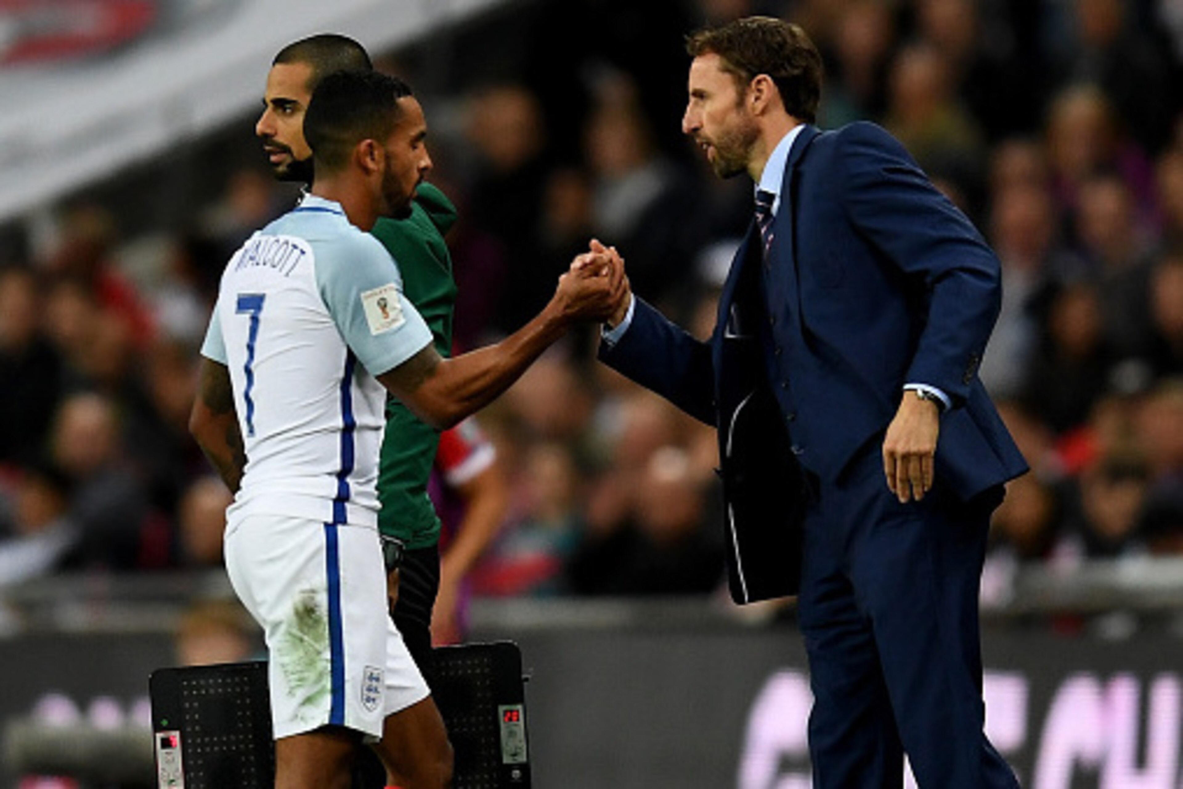 LONDON, ENGLAND - OCTOBER 08: Theo Walcott of England shakes hands with Gareth Southgate, Interim Manager of England during the FIFA 2018 World Cup Qualifier Group F match between England and Malta at Wembley Stadium on October 8, 2016 in London, England.