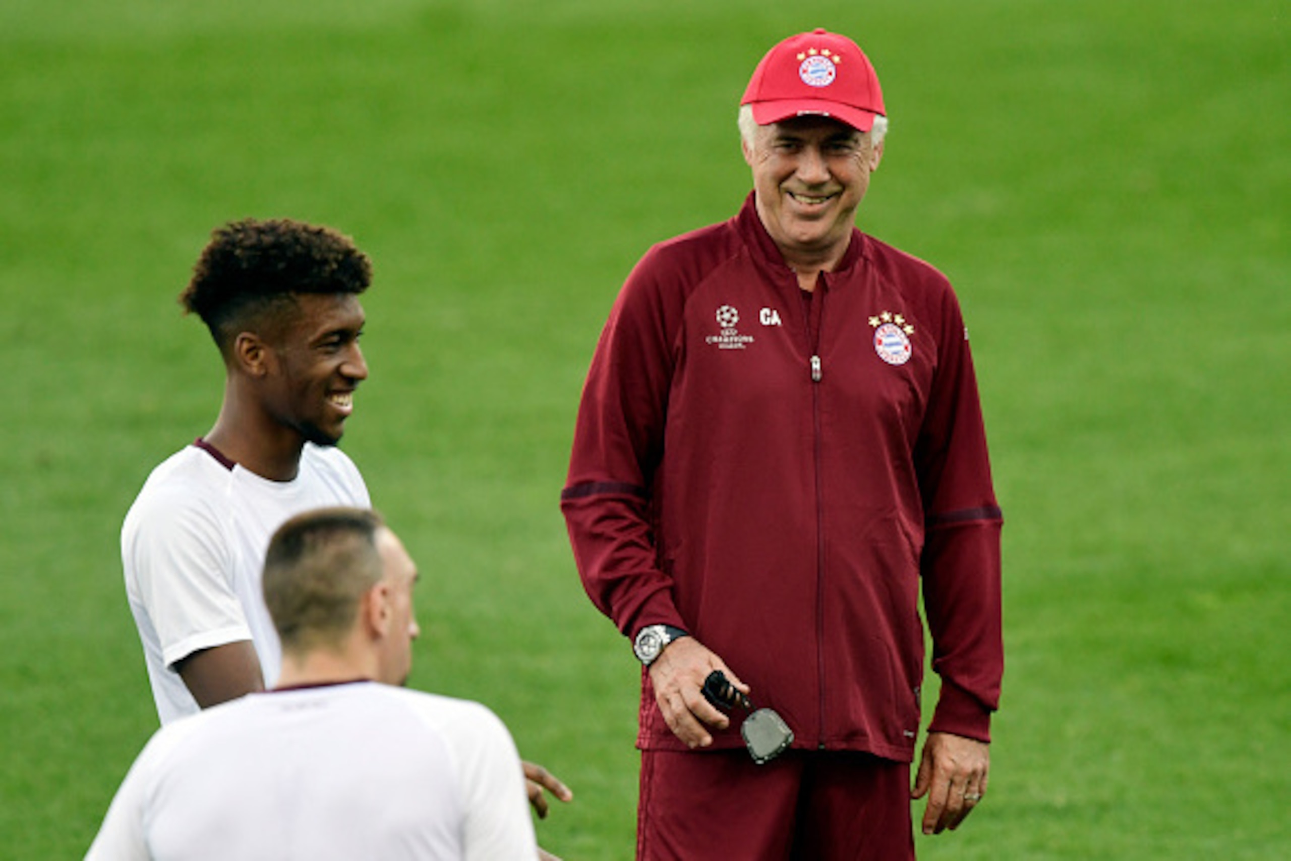 Bayern Munich's Italian head coach Carlo Ancelotti (R) smiles beside Bayern Munich's French forward Kingsley Coman during a training session at the Vicente Calderon stadium in Madrid on September 27, 2016 on the eve of their UEFA Champions league match ag Bayern Munich's Italian head coach Carlo Ancelotti (R) smiles beside Bayern Munich's French forward Kingsley Coman during a training session at the Vicente Calderon stadium in Madrid on September 27, 2016 on the eve of their UEFA Champions league match ag