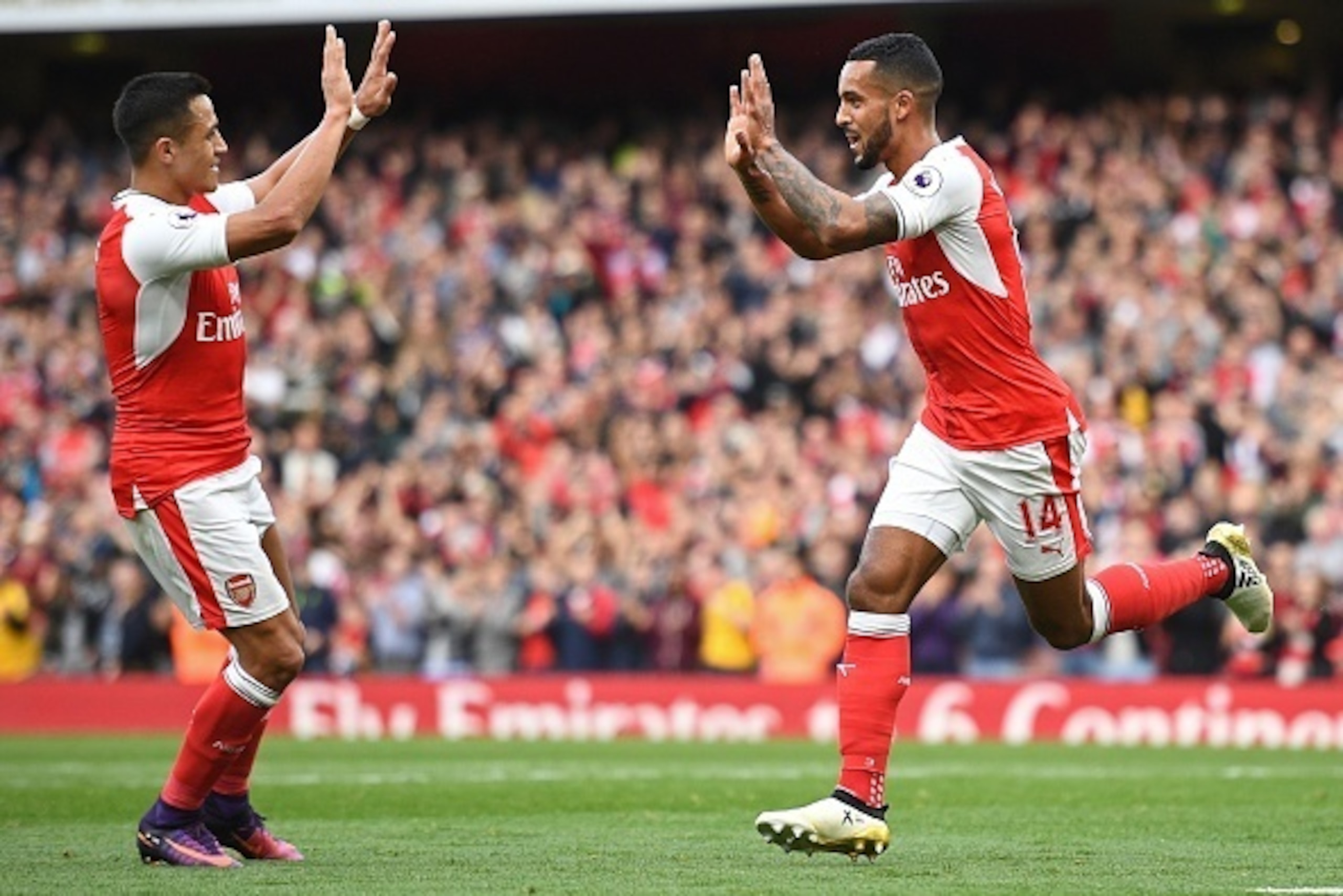 Arsenal's English midfielder Theo Walcott celebrates with Arsenal's Chilean striker Alexis Sanchez (L) after scoring their second goal during the English Premier League football match between Arsenal and Swansea City at the Emirates Stadium in London on O Arsenal's English midfielder Theo Walcott celebrates with Arsenal's Chilean striker Alexis Sanchez (L) after scoring their second goal during the English Premier League football match between Arsenal and Swansea City at the Emirates Stadium in London on O