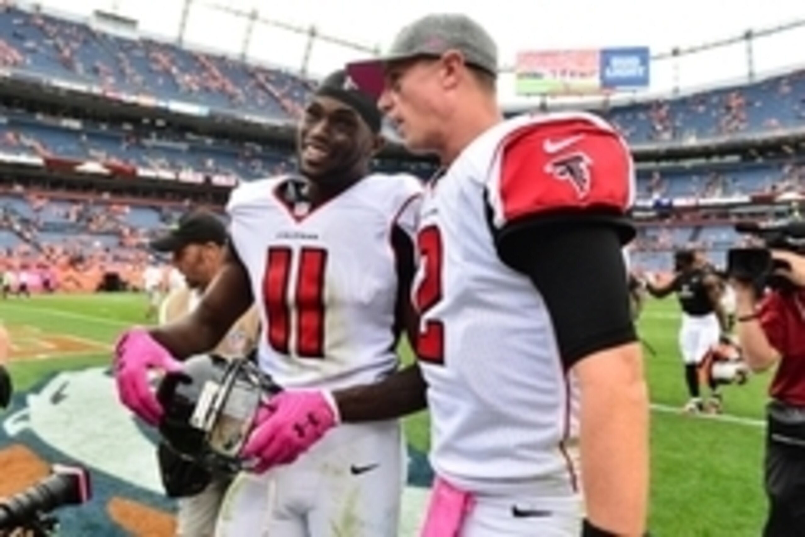 Oct 9, 2016; Denver, CO, USA; Atlanta Falcons wide receiver Julio Jones (11) and quarterback Matt Ryan (2) celebrate the win over the Denver Broncos in the second half at Sports Authority Field at Mile High. The Falcons defeated the Broncos 23-16. Mandato