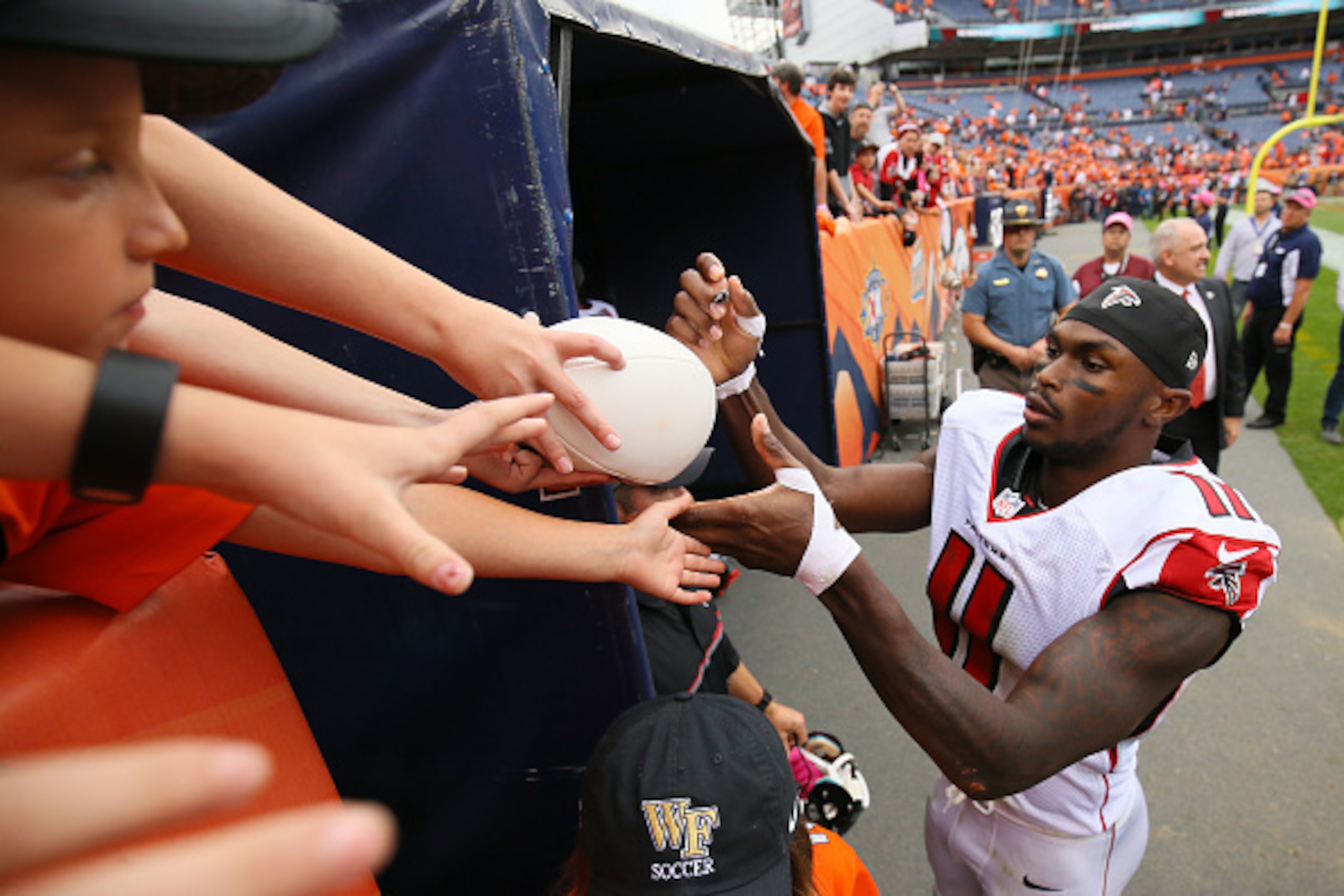 DENVER, CO - OCTOBER 9:  Wide receiver Julio Jones #11 of the Atlanta Falcons signs autographs after defeating the Denver Broncos 23-16 at Sports Authority Field at Mile High on October 9, 2016 in Denver, Colorado. (Photo by Justin Edmonds/Getty Images)