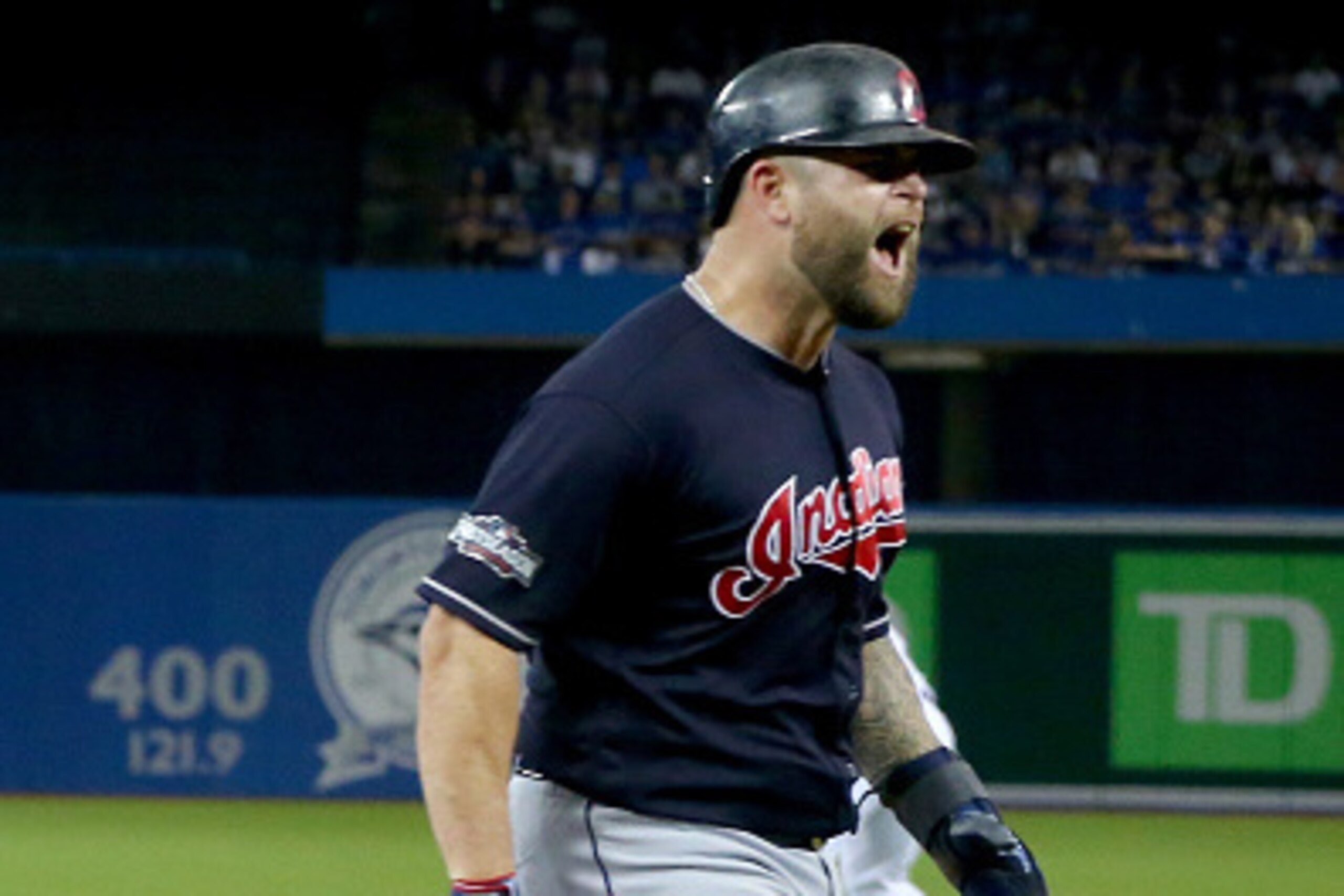 TORONTO, ON - OCTOBER 17:  Mike Napoli #26 of the Cleveland Indians celebrates after scoring a run off of a single hit by Jose Ramirez #11 in the sixth inning against Joe Biagini #31 of the Toronto Blue Jays during game three of the American League Champi