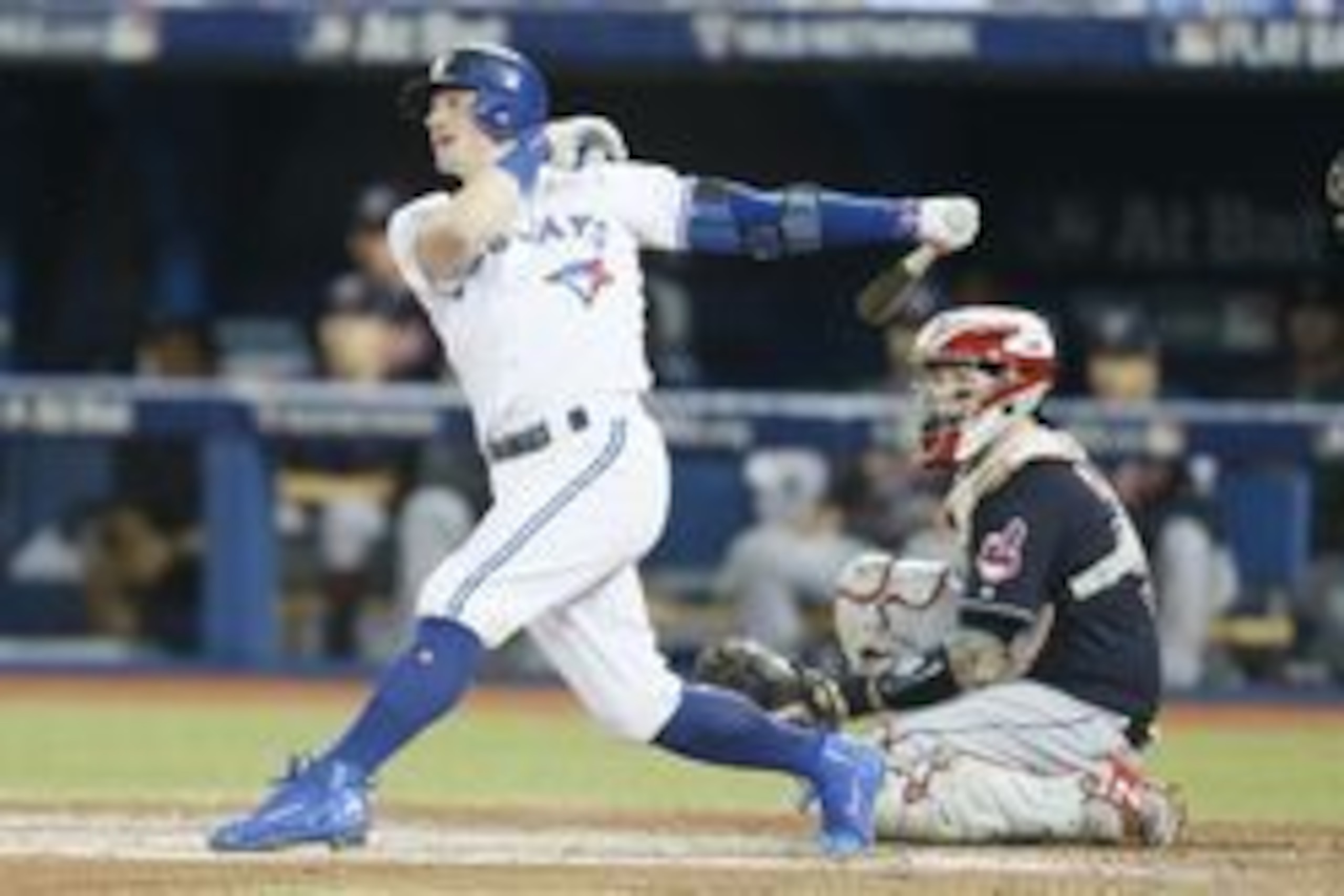 Oct 17, 2016; Toronto, Ontario, CAN; Toronto Blue Jays third baseman Josh Donaldson (left) hits a single against Cleveland Indians catcher Roberto Perez (right) during the fifth inning in game three of the 2016 ALCS playoff baseball series at Rogers Centr Oct 17, 2016; Toronto, Ontario, CAN; Toronto Blue Jays third baseman Josh Donaldson (left) hits a single against Cleveland Indians catcher Roberto Perez (right) during the fifth inning in game three of the 2016 ALCS playoff baseball series at Rogers Centr