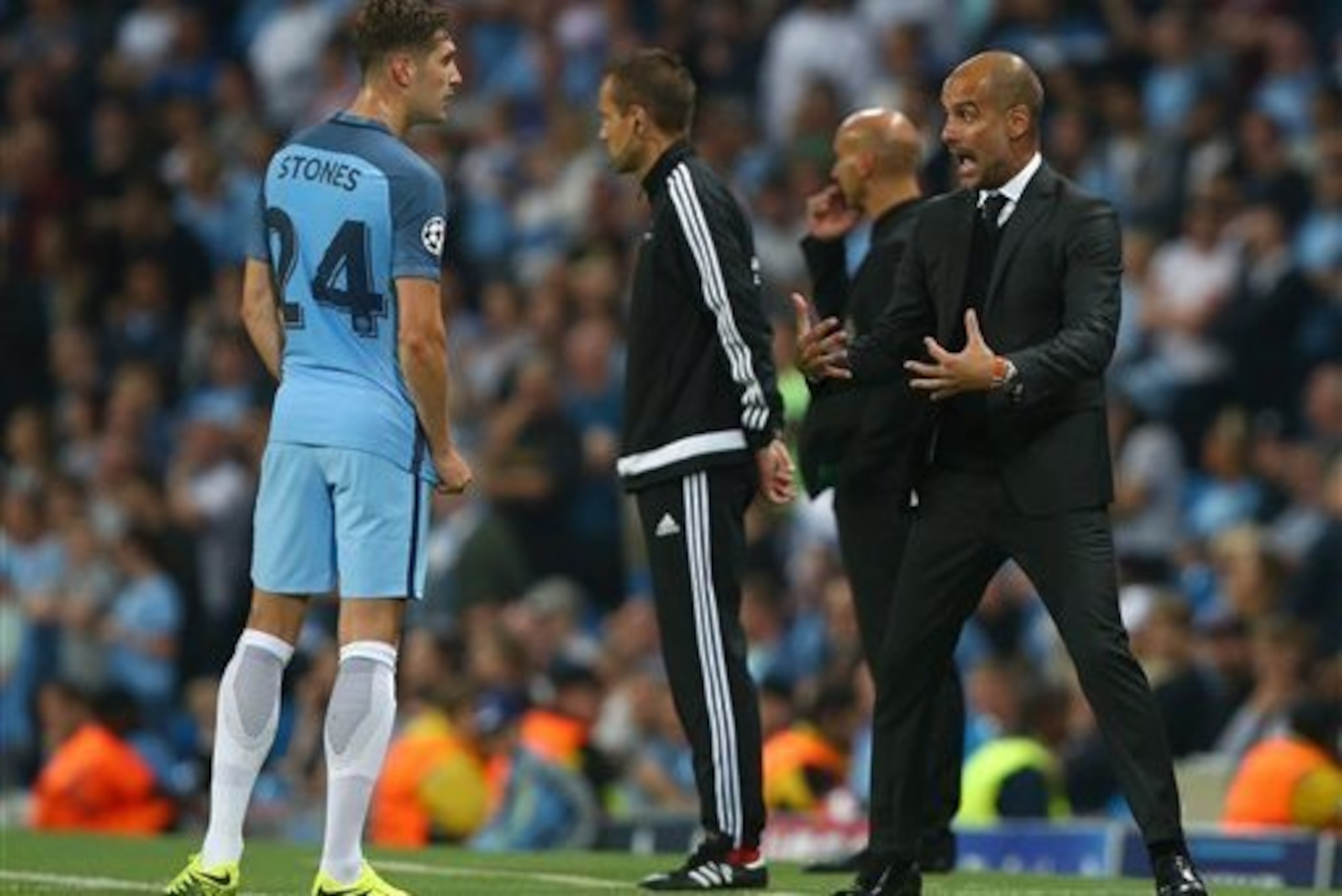 Guardiola educates John Stones.