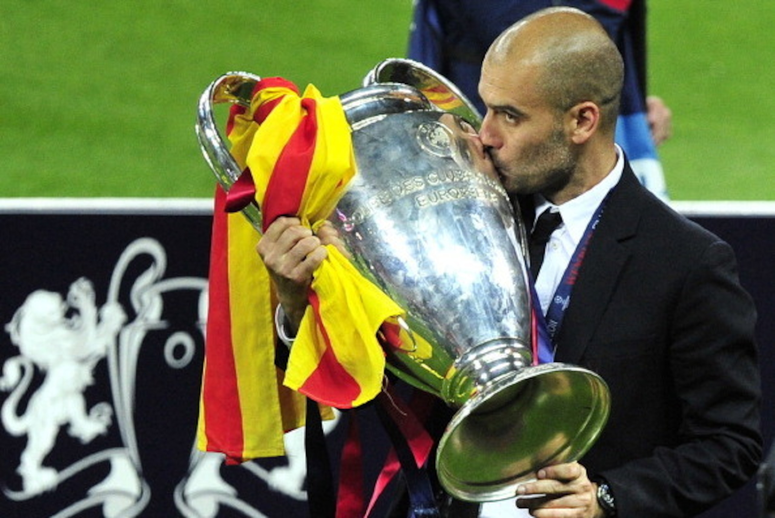 Barcelona's Spanish coach Josep Guardiola kisses the trophy at the end of the UEFA Champions League final football match FC Barcelona vs. Manchester United, on May 28, 2011 at Wembley stadium in London.Barcelona won 3 to 1. AFP PHOTO / GLYN KIRK (Photo cr