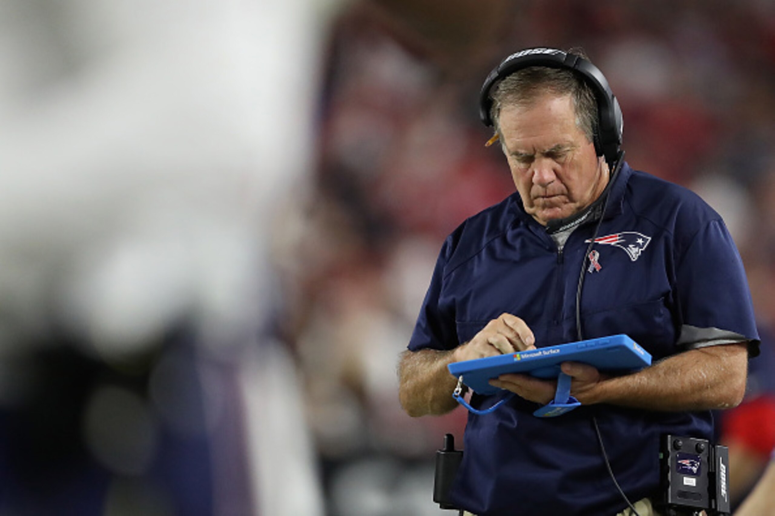 GLENDALE, AZ - SEPTEMBER 11:  Head coach Bill Belichick of the New England Patriots works on a microsoft surface tablet as he walks the sidelines during the NFL game against the Arizona Cardinals at the University of Phoenix Stadium on September 11, 2016 