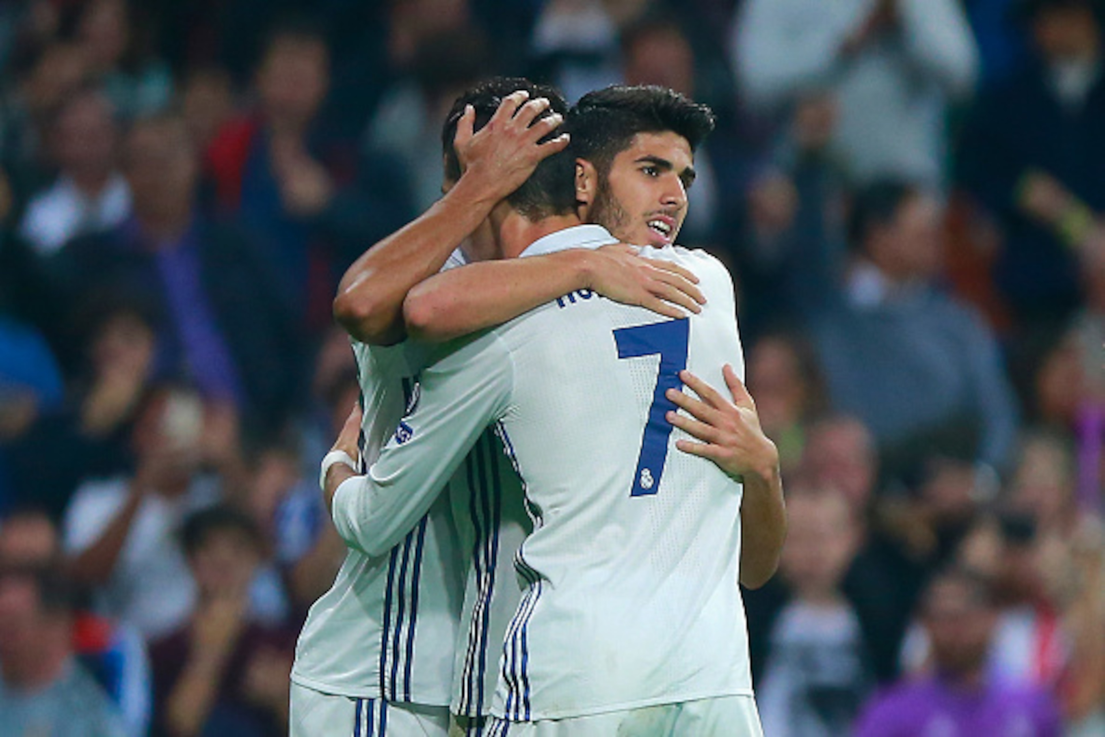 MADRID, SPAIN - OCTOBER 18: Marco Asensio (L) of Real Madrid celebrates scoring his team's third goal with his team mates Cristiano Ronaldo (R) during the UEFA Champions League Group F match between Real Madrid CF and Legia Warszawa at Bernabeu on October MADRID, SPAIN - OCTOBER 18: Marco Asensio (L) of Real Madrid celebrates scoring his team's third goal with his team mates Cristiano Ronaldo (R) during the UEFA Champions League Group F match between Real Madrid CF and Legia Warszawa at Bernabeu on October