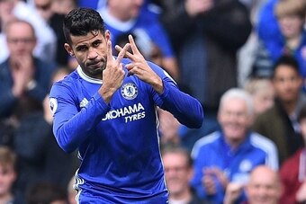 Chelsea's Brazilian-born Spanish striker Diego Costa celebrates with a gesture in support of Willian, who's mother passed away recently, after scoring the opening goal of the English Premier League football match between Chelsea and Leicester City at Stam