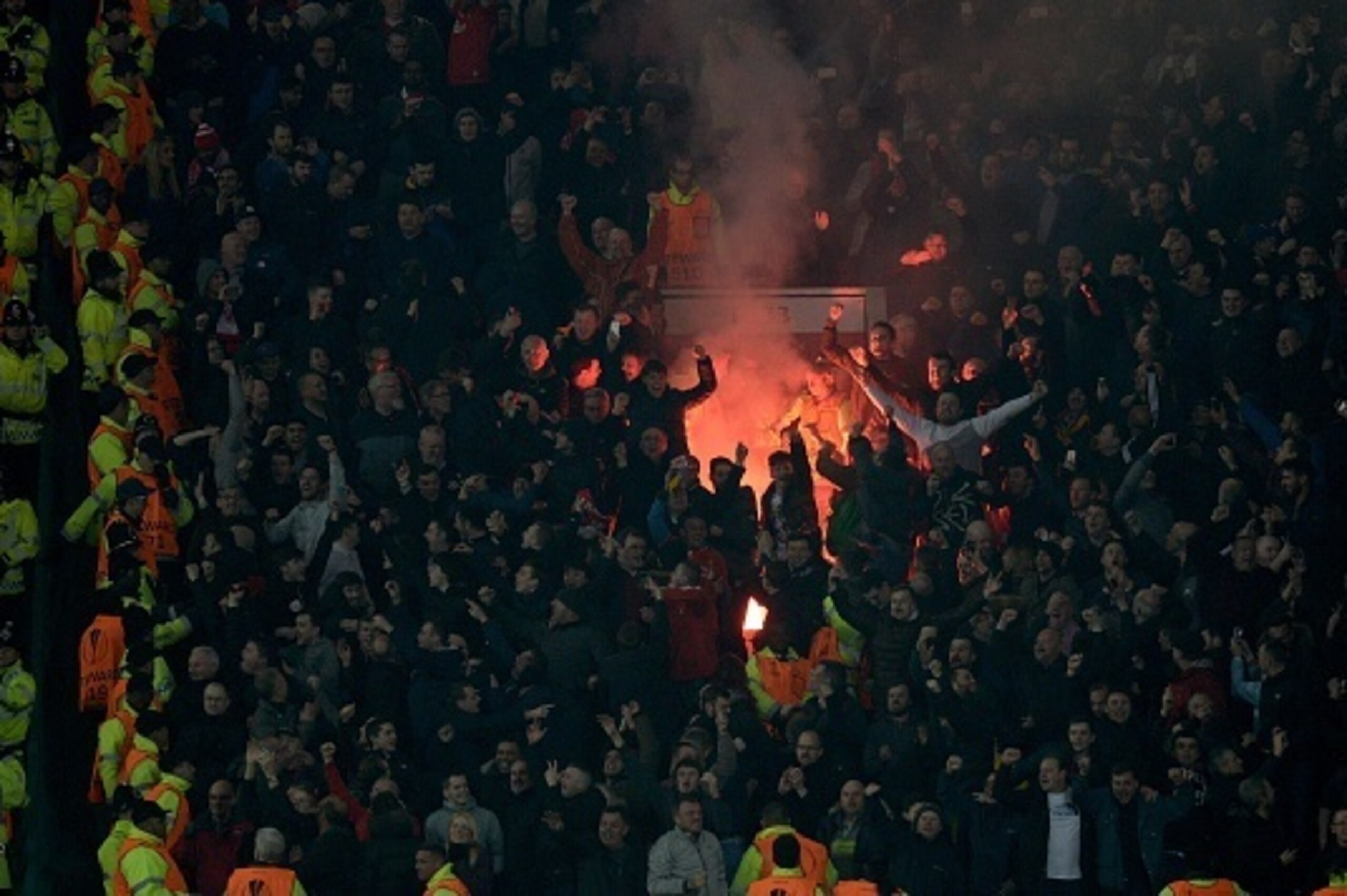 Flares are lit by the Liverpool supporters during the UEFA Europa League round of 16, second leg football match between Manchester United and Liverpool at Old Trafford in Manchester, north west England on March 17, 2016.
The game ended 1-1, Liverpool goin