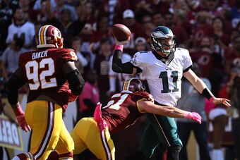LANDOVER, MD - OCTOBER 16: Quarterback Carson Wentz #11 of the Philadelphia Eagles is hit by inside linebacker Will Compton #51 of the Washington Redskins in the third quarter at FedExField on October 16, 2016 in Landover, Maryland. (Photo by Rob Carr/Get