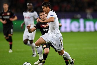 Leverkusen's Chilean midfielder Charles Aranguiz (L) and Tottenham Hotspur's South Korean striker Son Heung-Min vie for the ball during the Champions League group E football match between Bayer Leverkusen and Tottenham Hotspur in Leverkusen, western Germa