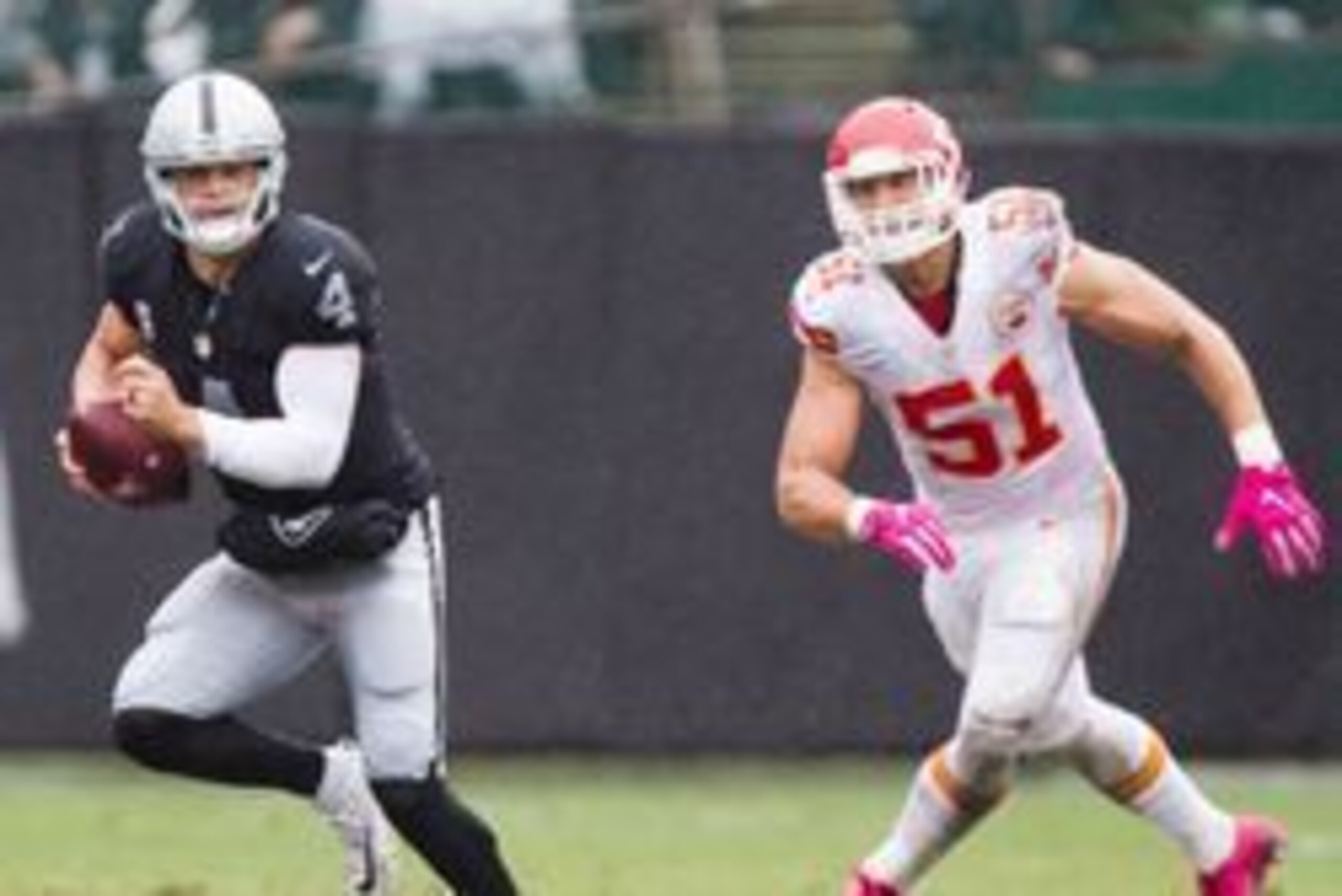 Oct 16, 2016; Oakland, CA, USA; Oakland Raiders quarterback Derek Carr (4) runs with the ball in front of Kansas City Chiefs outside linebacker Frank Zombo (51) during the second quarter at Oakland Coliseum. Mandatory Credit: Kelley L Cox-USA TODAY Sports