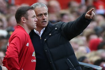 Manchester United's Portuguese manager Jose Mourinho (R) gives instructions to Manchester United's English striker Wayne Rooney as he comes on as a substitute during the English Premier League football match between Manchester United and Stoke City at Old