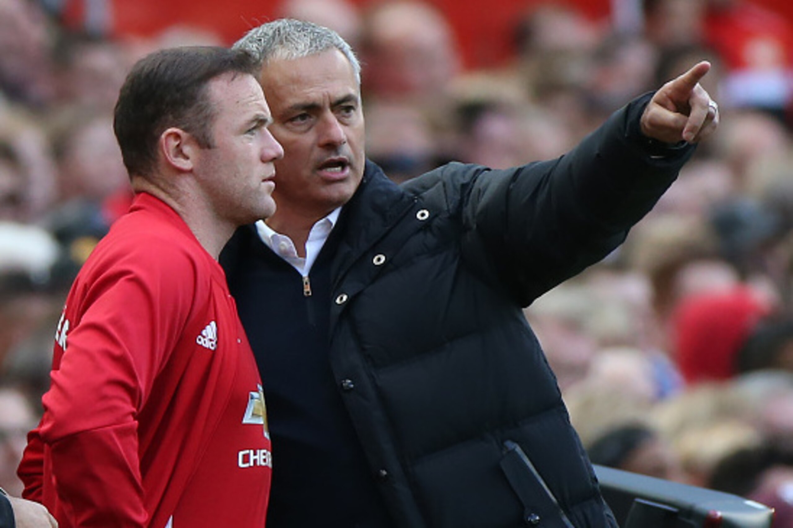 Manchester United's Portuguese manager Jose Mourinho (R) gives instructions to Manchester United's English striker Wayne Rooney as he comes on as a substitute during the English Premier League football match between Manchester United and Stoke City at Old