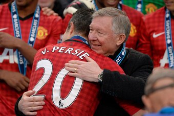 MANCHESTER, UNITED KINGDOM - MAY 12:  Sir Alex Ferguson hugs Robin Van Persie at the trophy presentation after the Manchester United versus Swansea City FA Premier League match, the final home game for Sir Alex Ferguson as United manager, at Old Trafford 
