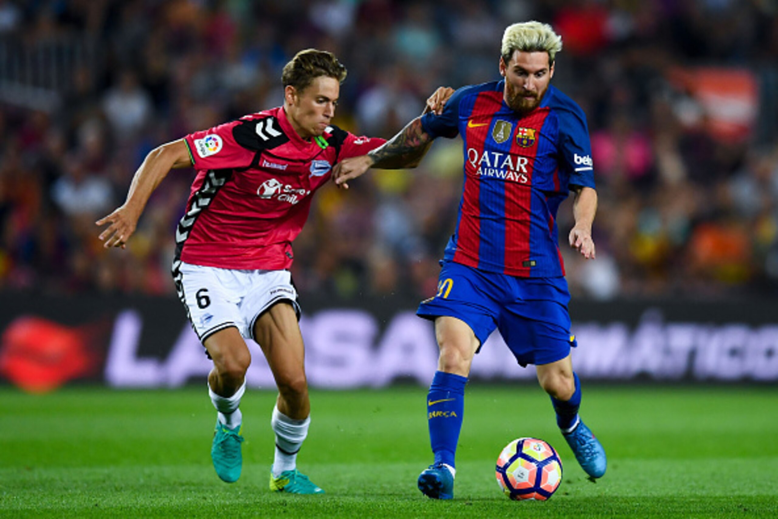 BARCELONA, SPAIN - SEPTEMBER 10:  Lionel Messi of FC Barcelona competes for the ball with Marcos Llorente of Deportivo Alaves during the La Liga match between FC Barcelona and Deportivo Alaves at Camp Nou stadium on September 10, 2016 in Barcelona, Spain.