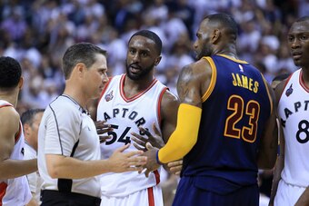 TORONTO, ON - MAY 23: Patrick Patterson #54 of the Toronto Raptors and LeBron James #23 of the Cleveland Cavaliers react with an official after a foul in the second half in game four of the Eastern Conference Finals during the 2016 NBA Playoffs at the Air