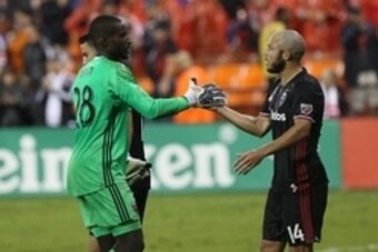 Sep 28, 2016; Washington, DC, USA; D.C. United goalkeeper Bill Hamid (28) celebrates with D.C. United midfielder Nick DeLeon (14) after their game against Columbus Crew SC at Robert F. Kennedy Memorial Stadium. United won 3-0. Mandatory Credit: Geoff Burk
