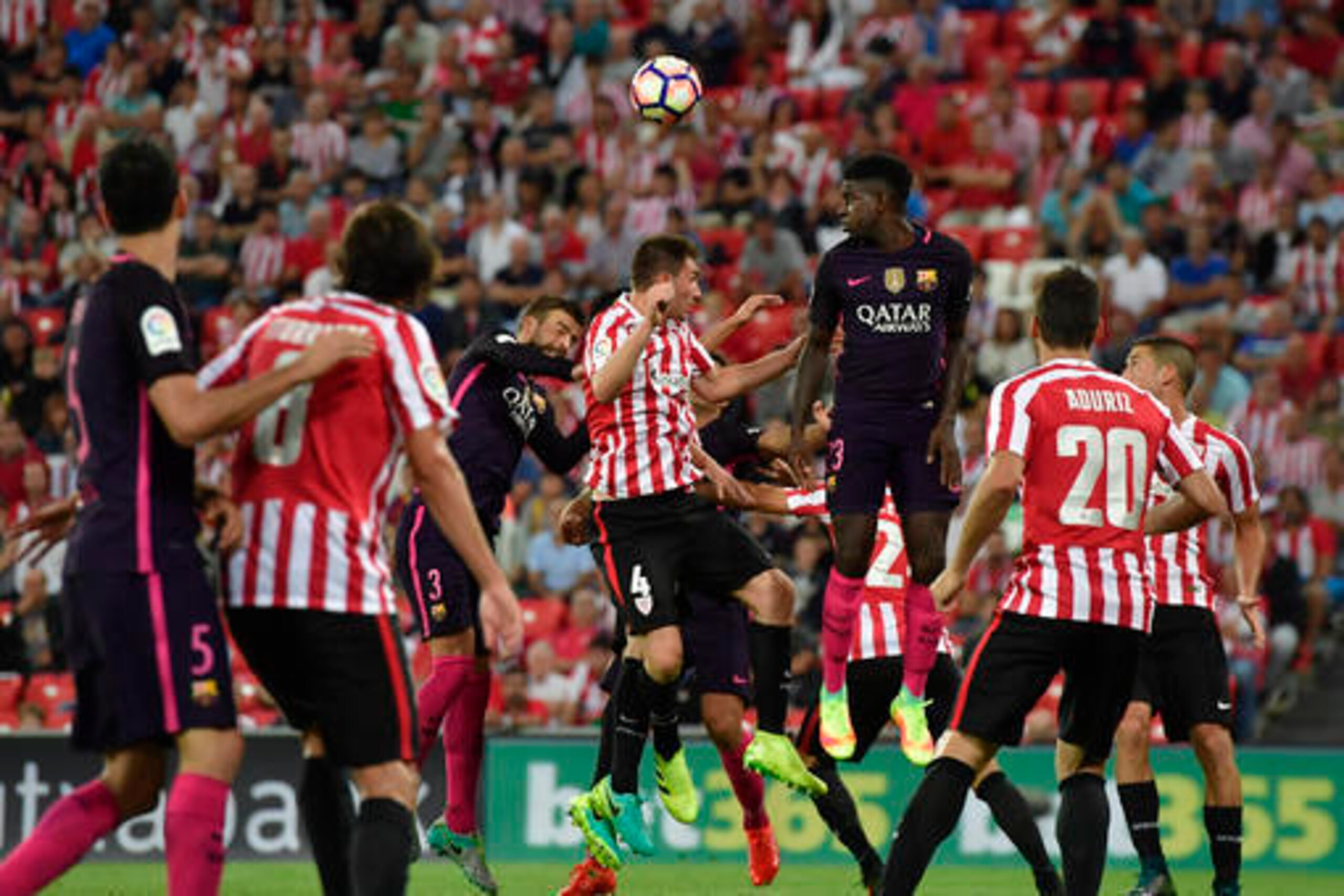 Umtiti rises to head the ball to safety.