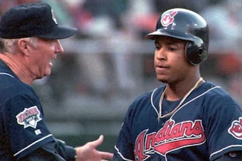 OAKLAND, :  Cleveland Indian Manny Ramirez is congratulated by manager Mike Hargrove after hitting a three run homerun, his 22 of the year, off of Oakland Athletics Todd Stottlemyre in the fourth inning 21 July. The Indians won their fourth game in a row 