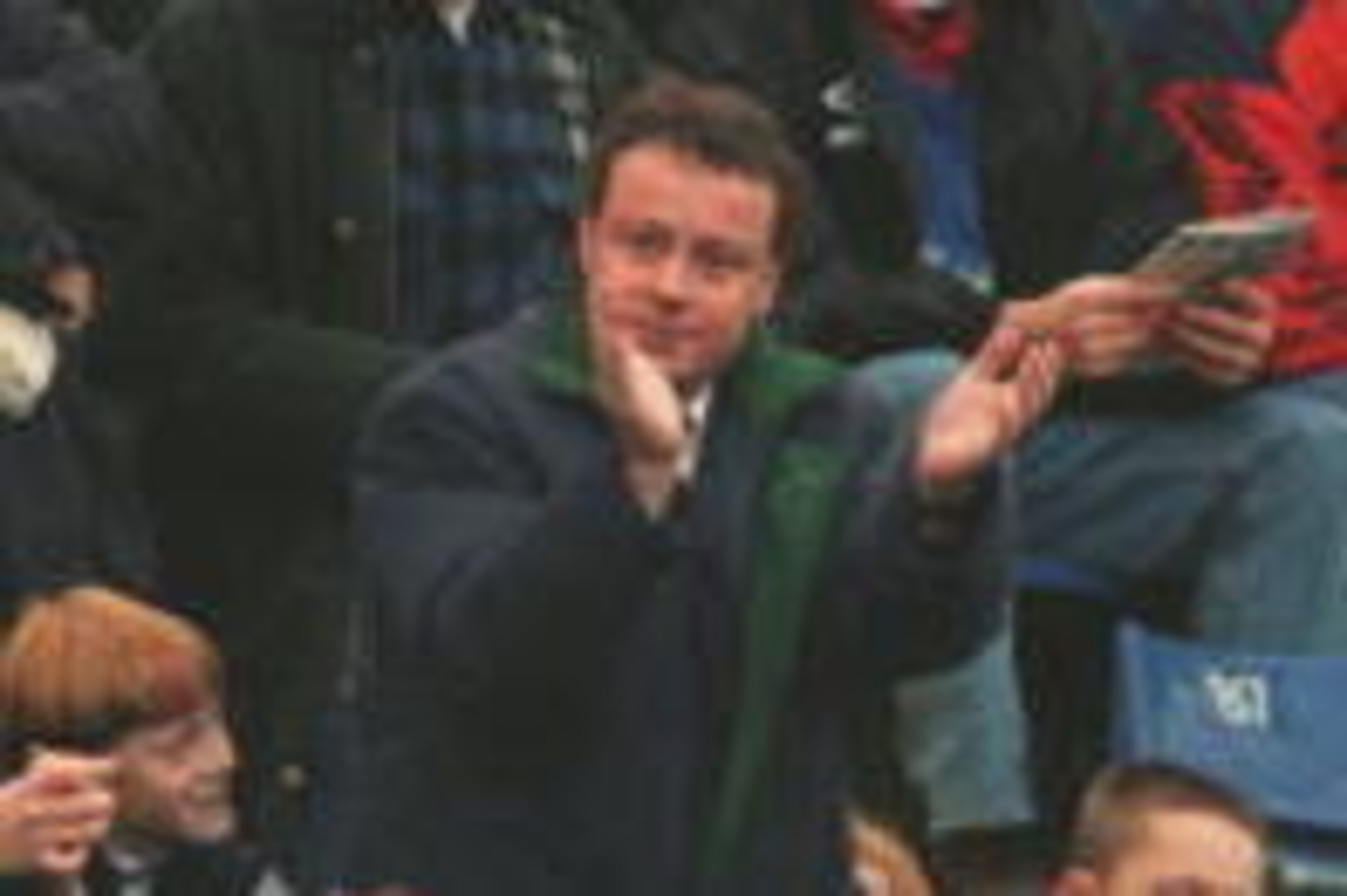 25 NOV 1995: MATTHEW HARDING, THE CHELSEA DIRECTOR BANNED BY KEN BATES THE CHELSEA CHAIRMAN FROM ENTERING THE DIRECTORS BOX AT STAMFORD BRIDGE, WAVES TO FANS FROM HIS SEAT IN THE NORTH STAND DURING THE FA PREMIERSHIP MATCH BETWEEN CHELSEA AND TOTTENHAM HO