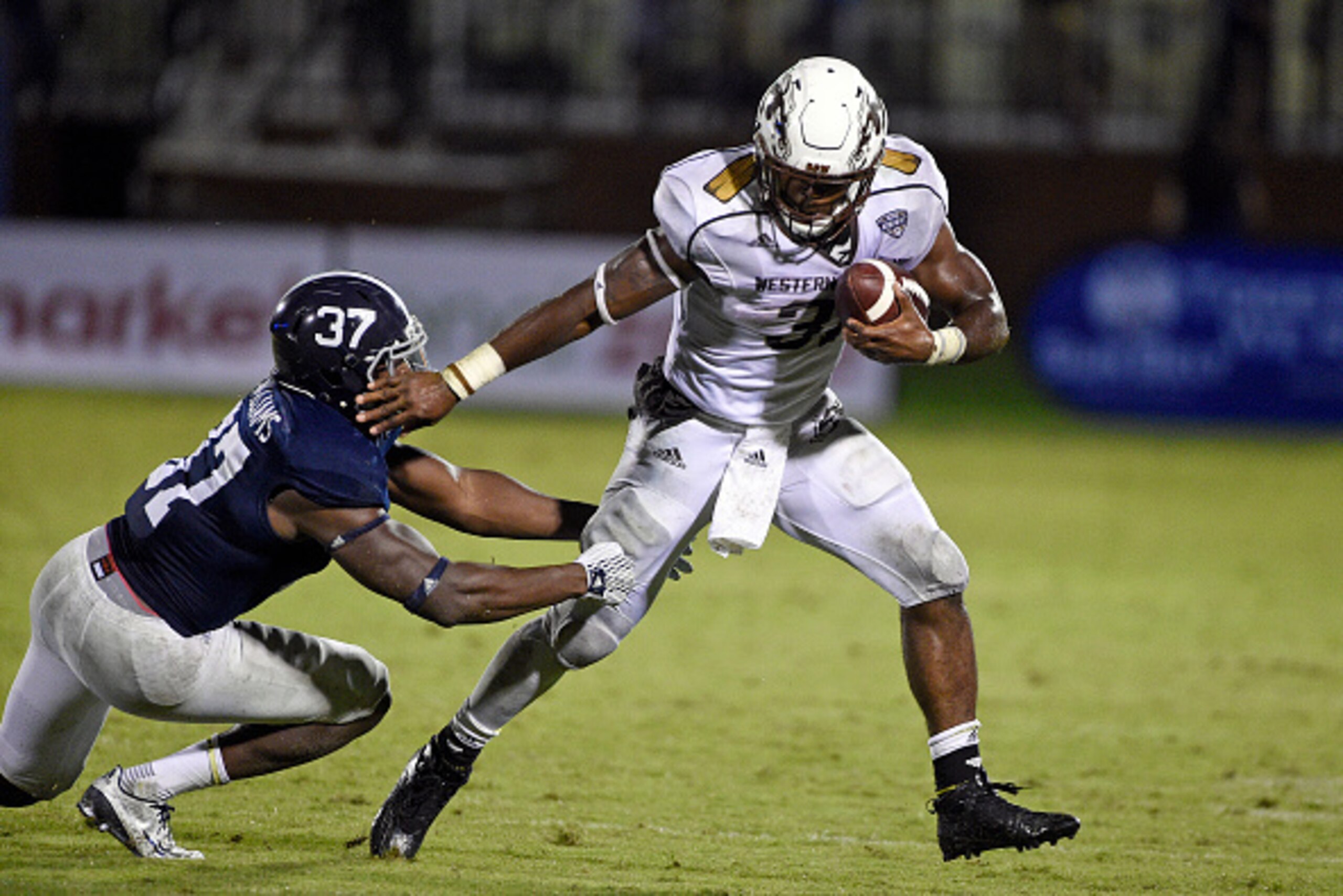 STATESBORO, GA - SEPTEMBER 12:  Running back Jarvion Franklin #31 of the Western Michigan Broncos tries to break a tackle by linebacker Antwione Williams #37 of the Georgia Southern Eagles during the fourth quarter on September 12, 2015 at Paulson Stadium