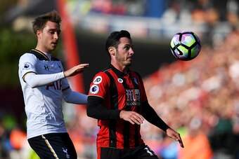 BOURNEMOUTH, ENGLAND - OCTOBER 22: Adam Smith of AFC Bournemouth (R) controls the ball while under pressure from Christian Eriksen of Tottenham Hotspur (L) during the Premier League match between AFC Bournemouth and Tottenham Hotspur at Vitality Stadium o