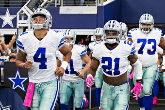 ARLINGTON, TX - OCTOBER 09: Ezekiel Elliott #21 and Dak Prescott #4 run onto the field before a game against the Cincinnati Bengals at AT&T Stadium on October 9, 2016 in Arlington, Texas. The Cowboys defeated the Bengals 28-14.  (Photo by Wesley Hitt/Gett