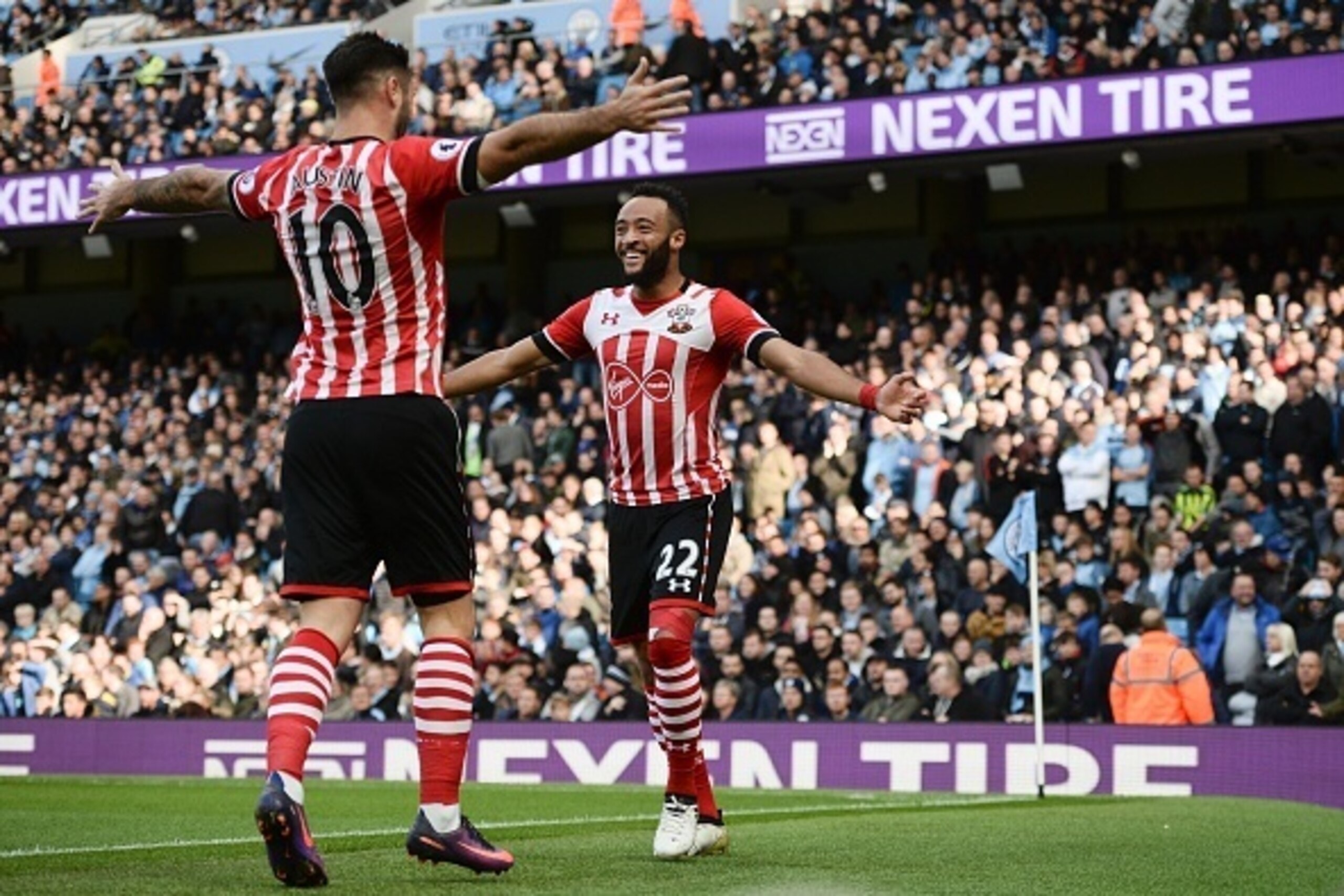 Southampton's English midfielder Nathan Redmond (R) celebrates with Southampton's English striker Charlie Austin after scoring the opening goal of the English Premier League football match between Manchester City and Southampton at the Etihad Stadium in M