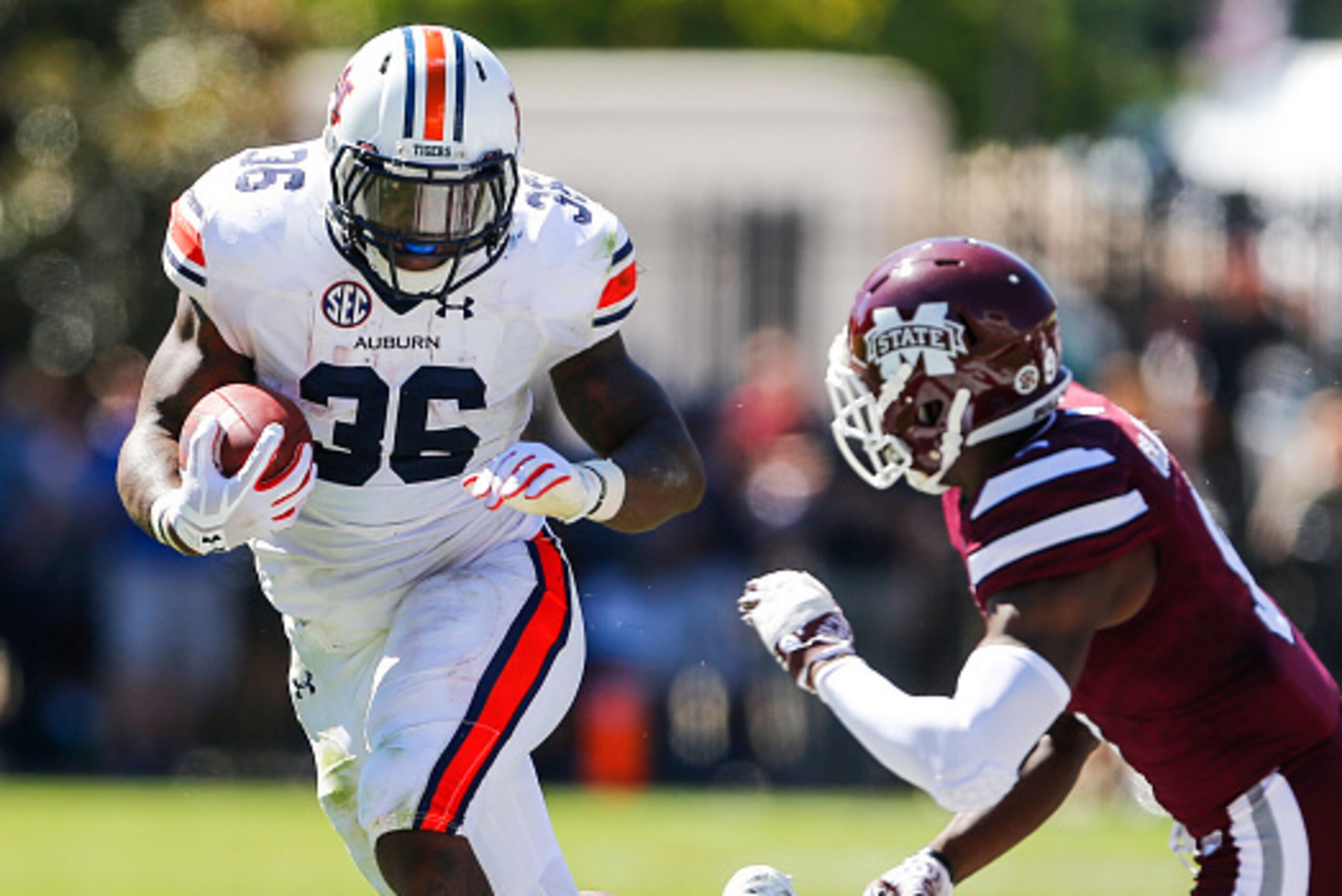 STARKVILLE, MS - OCTOBER 8:   Running back Kamryn Pettway #36 of the Auburn Tigers tries to get around defensive back Jamoral Graham #9 of the Mississippi State Bulldogs as he carries the ball during the first half of an NCAA college football game on Oct.