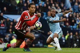 Manchester City's English midfielder Raheem Sterling (R) has an unsuccessful shot during the English Premier League football match between Manchester City and Southampton at the Etihad Stadium in Manchester, north west England, on October 23, 2016. / AFP 