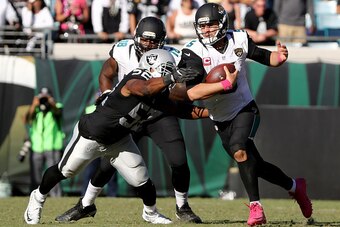 JACKSONVILLE, FL - OCTOBER 23:   Khalil Mack #52 of the Oakland Raiders tackles Blake Bortles #5 of the Jacksonville Jaguars during the game at EverBank Field on October 23, 2016 in Jacksonville, Florida.  (Photo by Sam Greenwood/Getty Images)