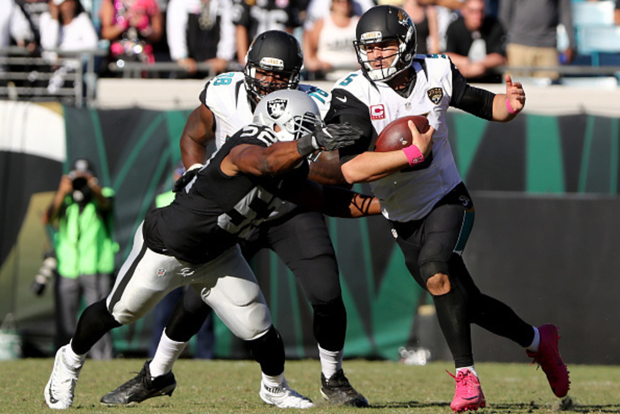 JACKSONVILLE, FL - OCTOBER 23:   Khalil Mack #52 of the Oakland Raiders tackles Blake Bortles #5 of the Jacksonville Jaguars during the game at EverBank Field on October 23, 2016 in Jacksonville, Florida.  (Photo by Sam Greenwood/Getty Images)