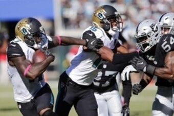 Oct 23, 2016; Jacksonville, FL, USA; Jacksonville Jaguars wide receiver Allen Robinson (15) blocks Oakland Raiders outside linebacker Perry Riley (54) so that Jaguars wide receiver Marqise Lee (11) can run the ball during the second half of  a football ga